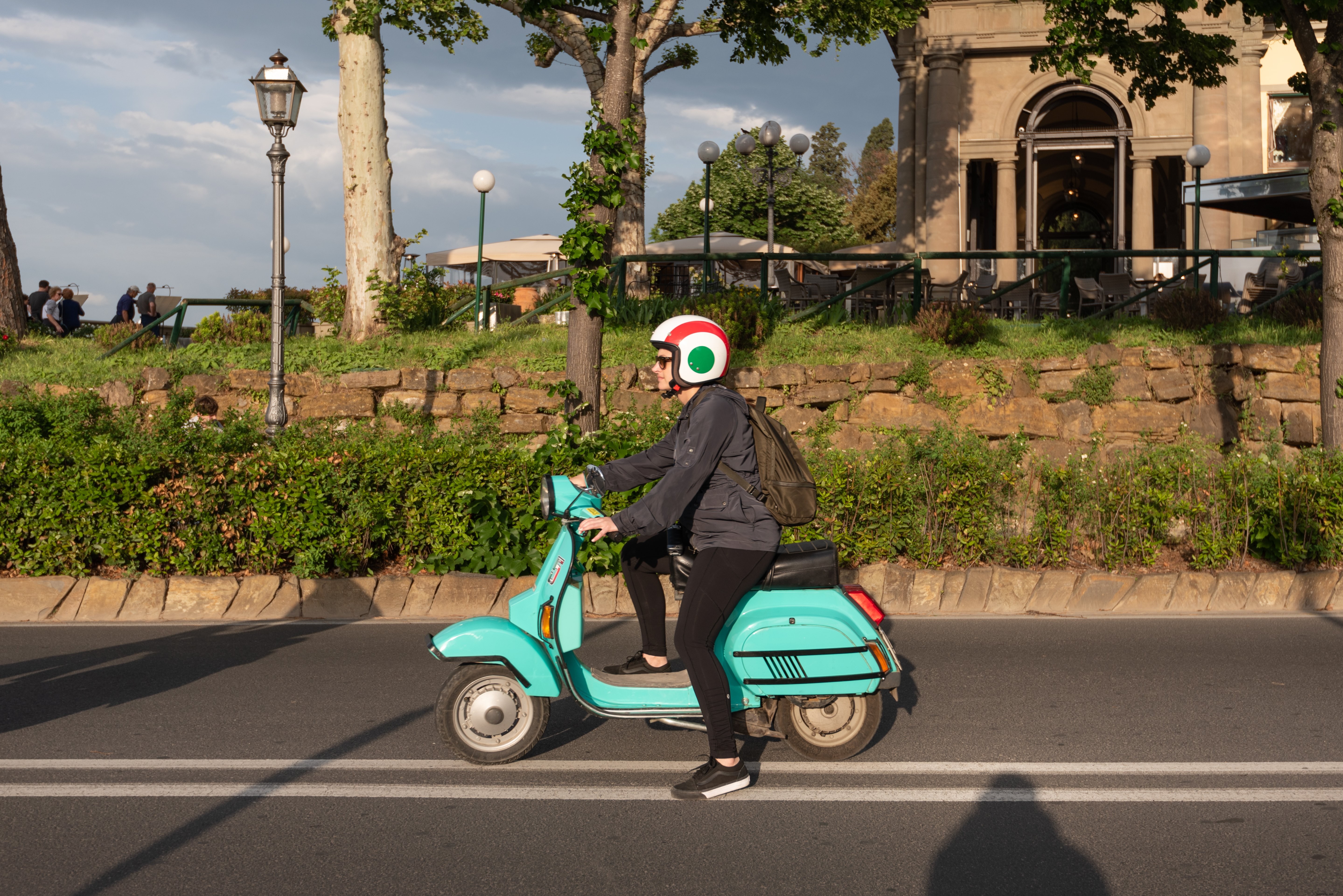 Stunning Photo: Woman Riding Turquoise Moped on Scenic Highway