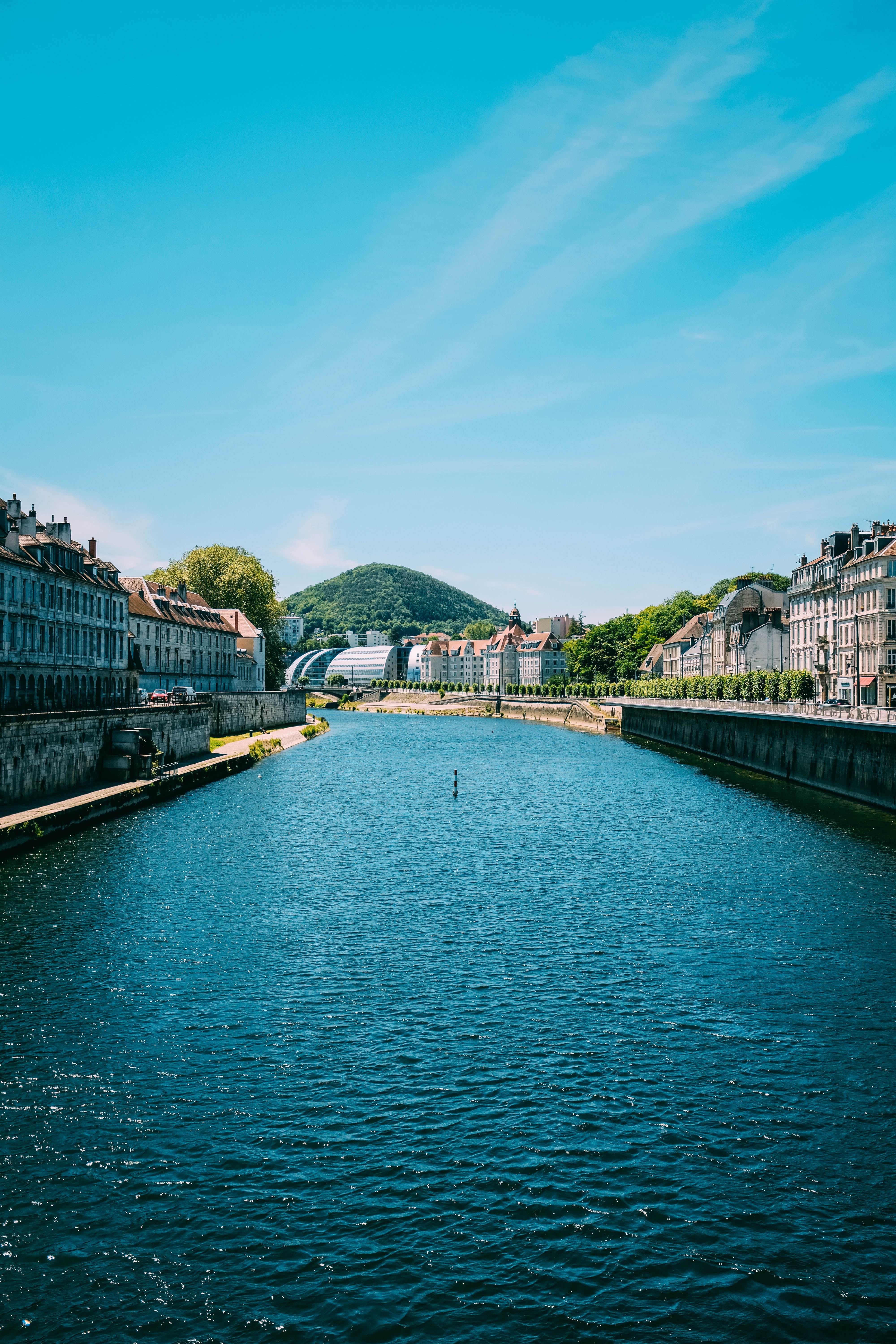 Stunning Photo: River Carving from Majestic Mountains Through a Picturesque Town