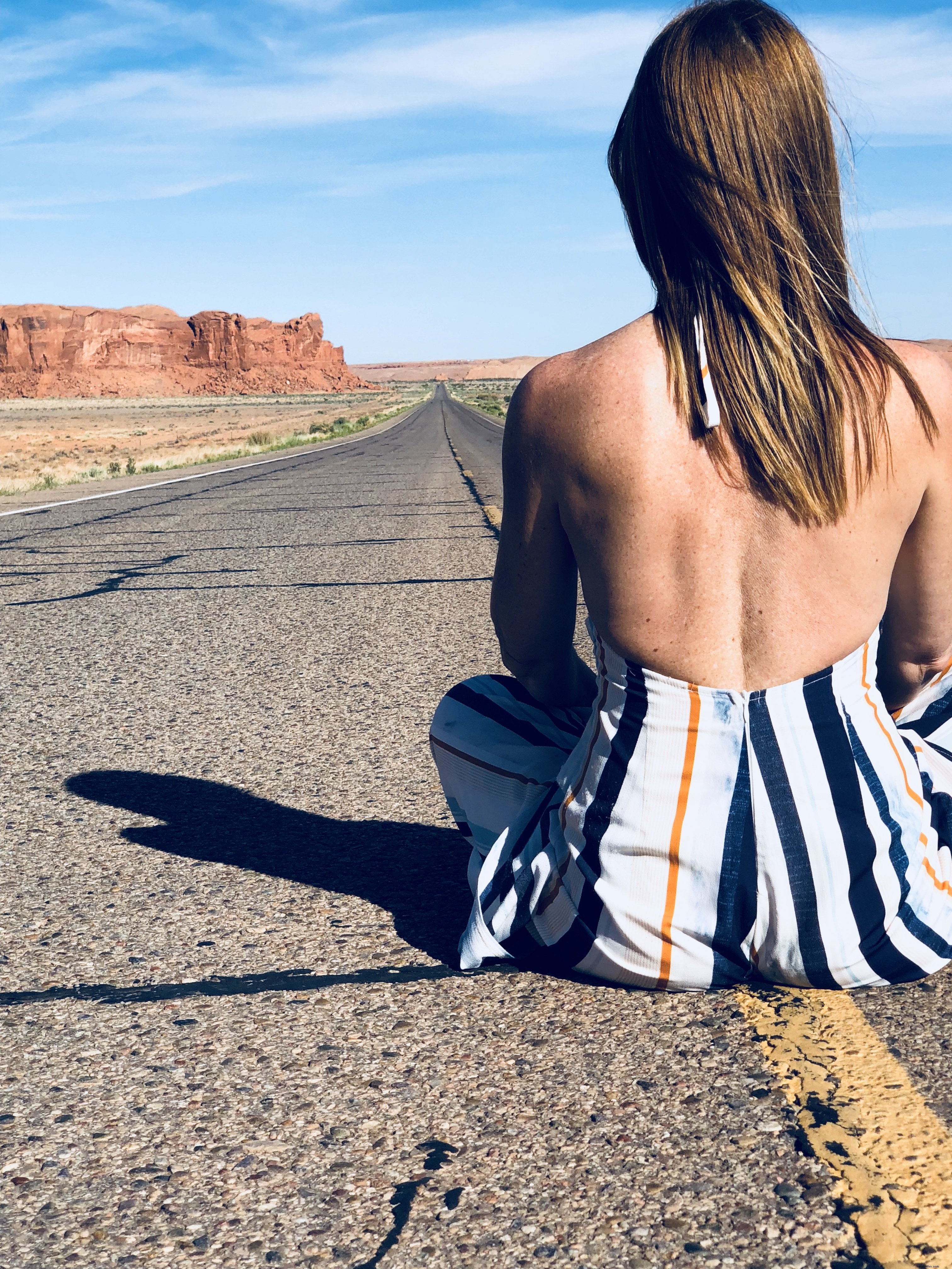 Captivating Photo: Woman Sits Boldly in the Heart of Desert Highway
