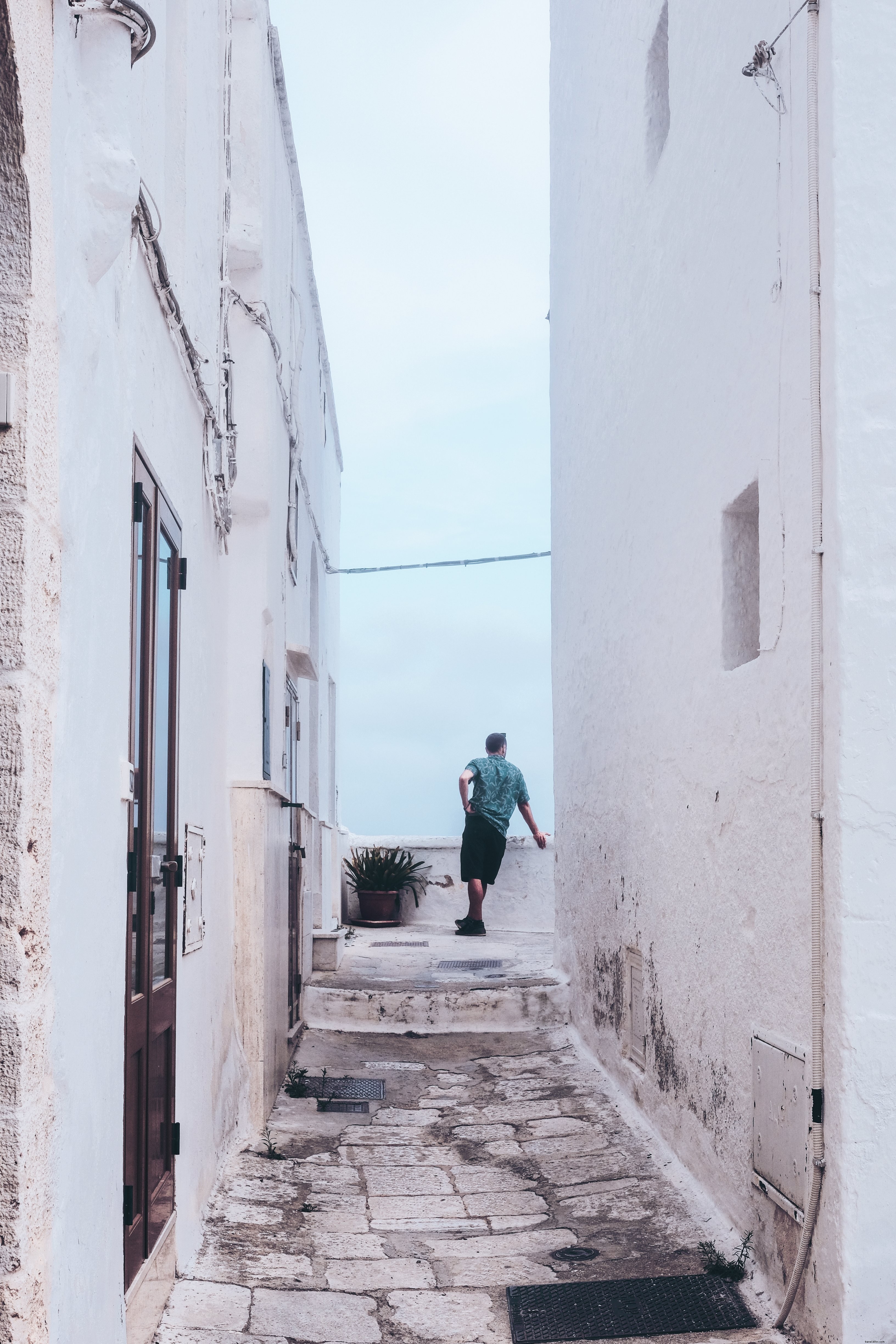 Stunning White Alleyway: Lone Figure Pausing to Admire the View