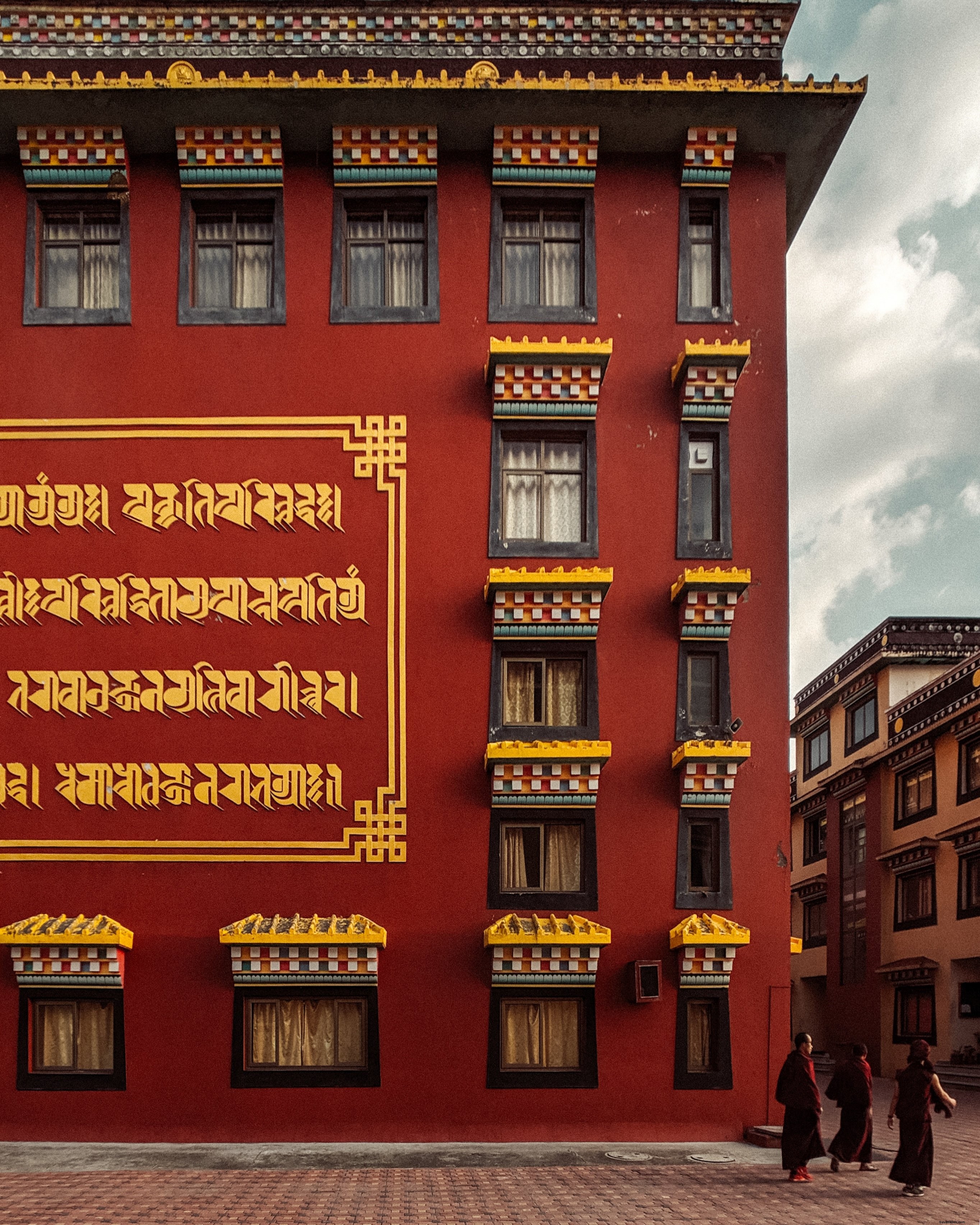 Stunning Photo: Crimson Building with Elegant Gold Inscriptions on Walls