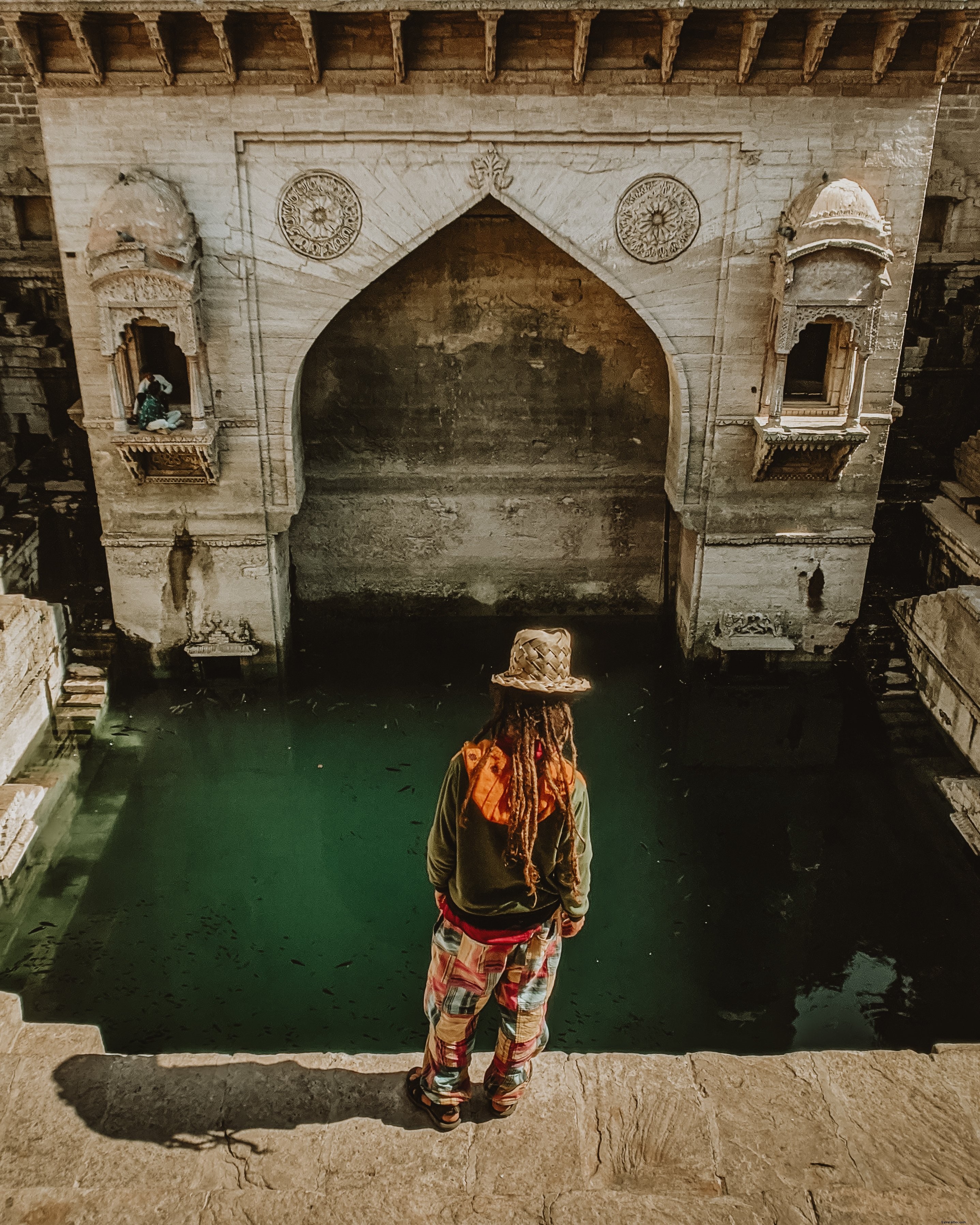 Breathtaking Photo: Person Poised at the Edge of a Rocky Pond