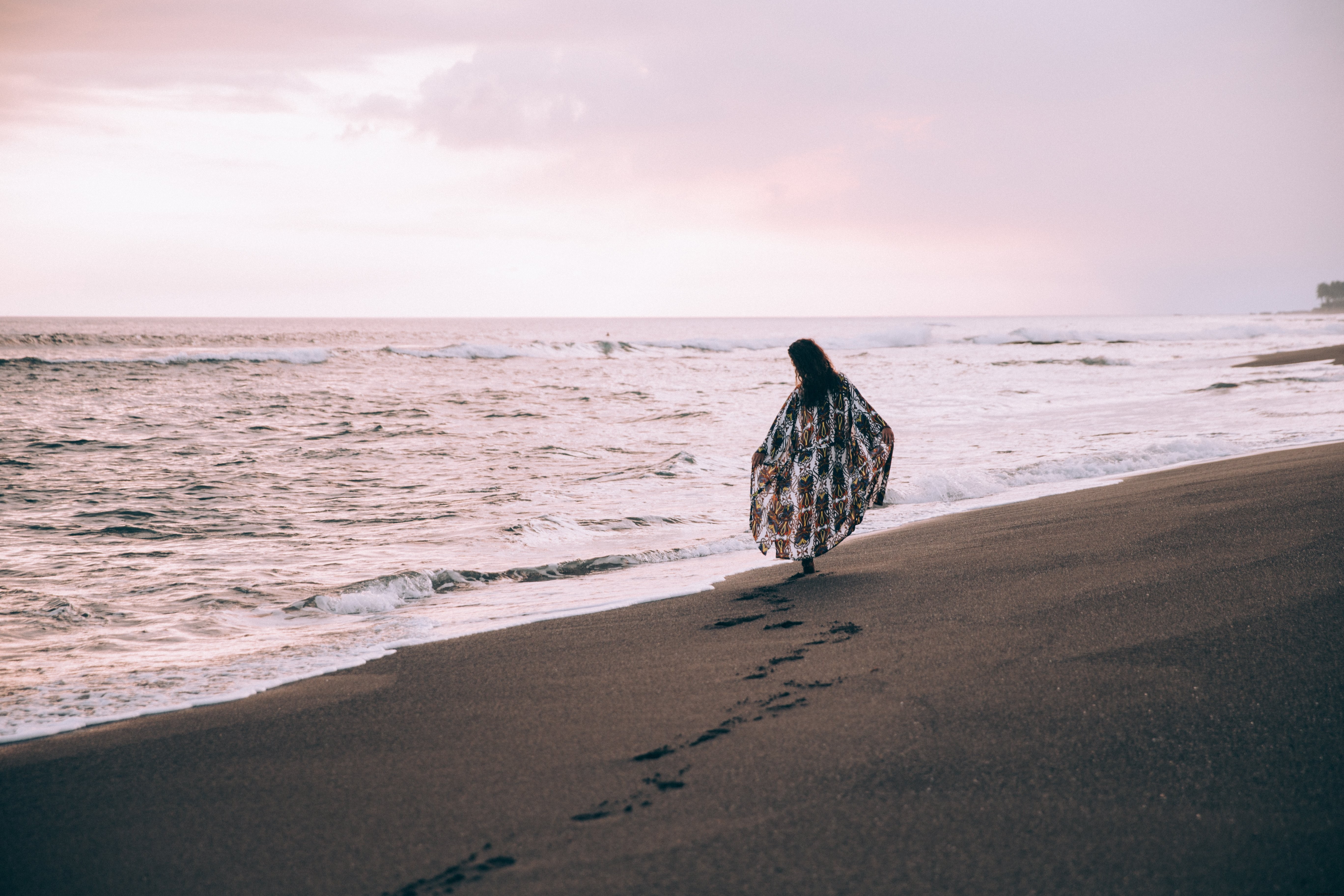 Stunning Beach Scene: Woman Walking, Leaving Footprints in the Sand