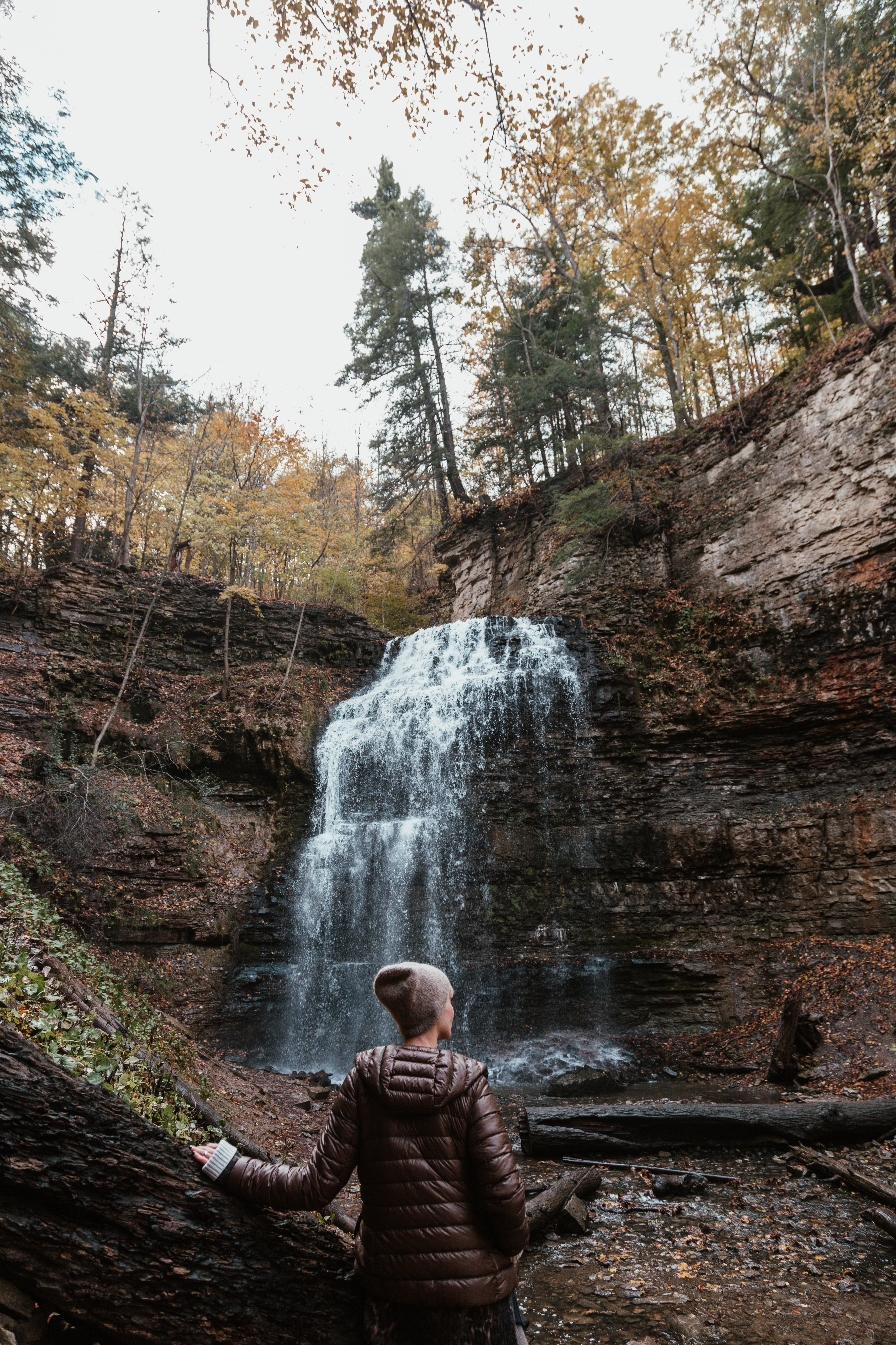 Stunning Model Posing by Majestic Waterfall – Professional Photography