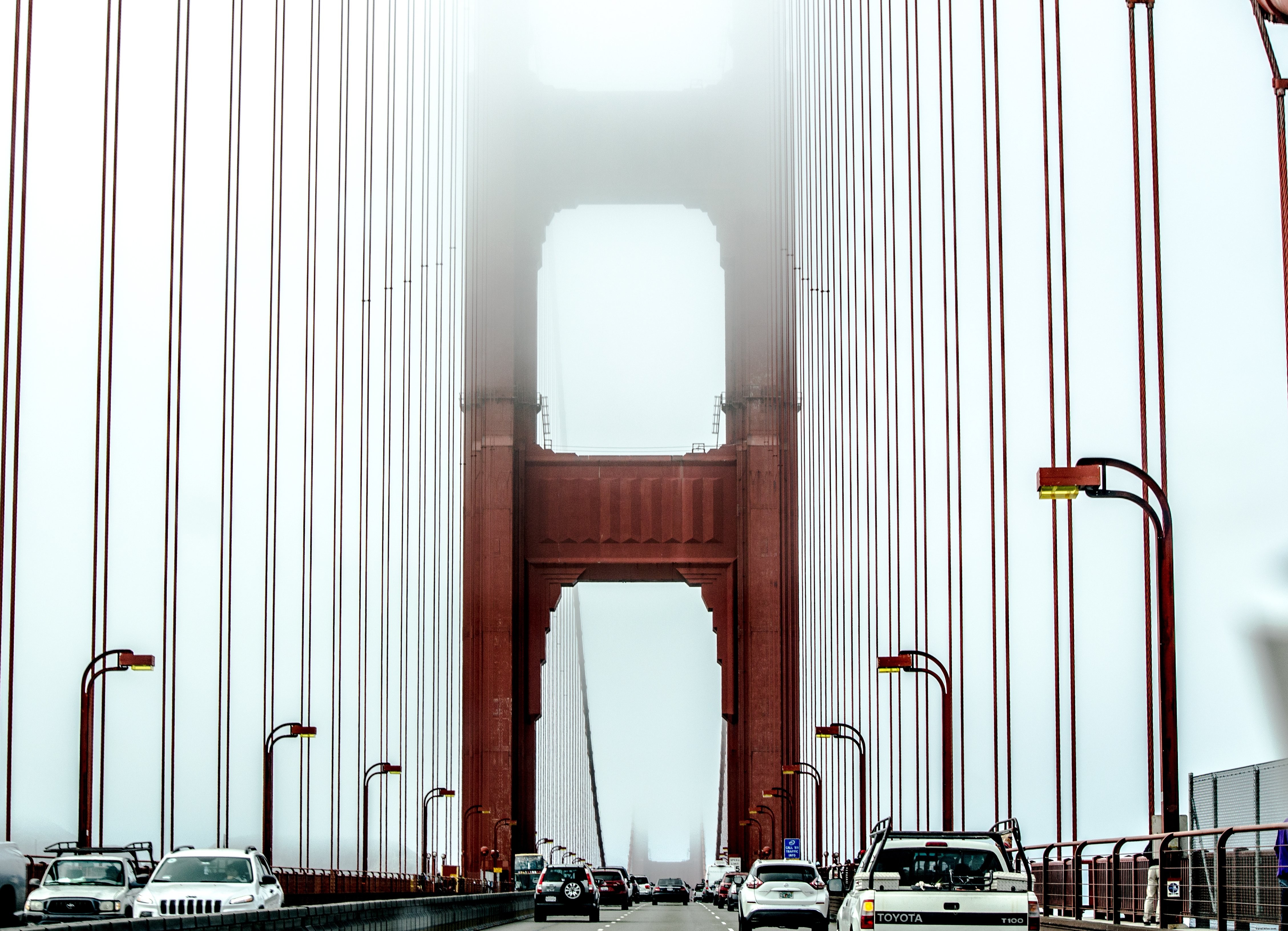 Stunning Photo: Traffic Navigating a Mist-Shrouded Suspension Bridge