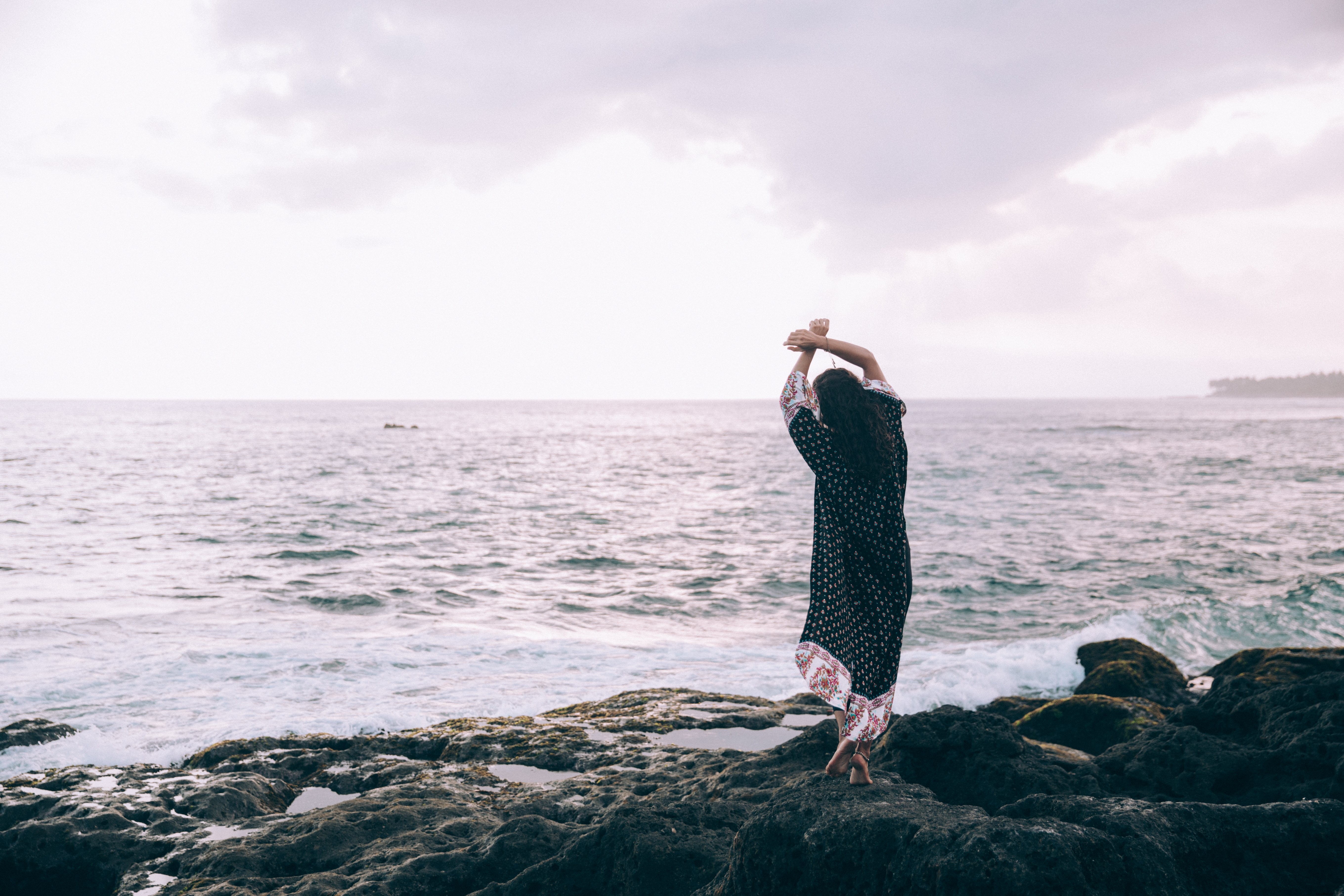 Elegant Woman in Beach Robe Poses Gracefully on Sunny Shore