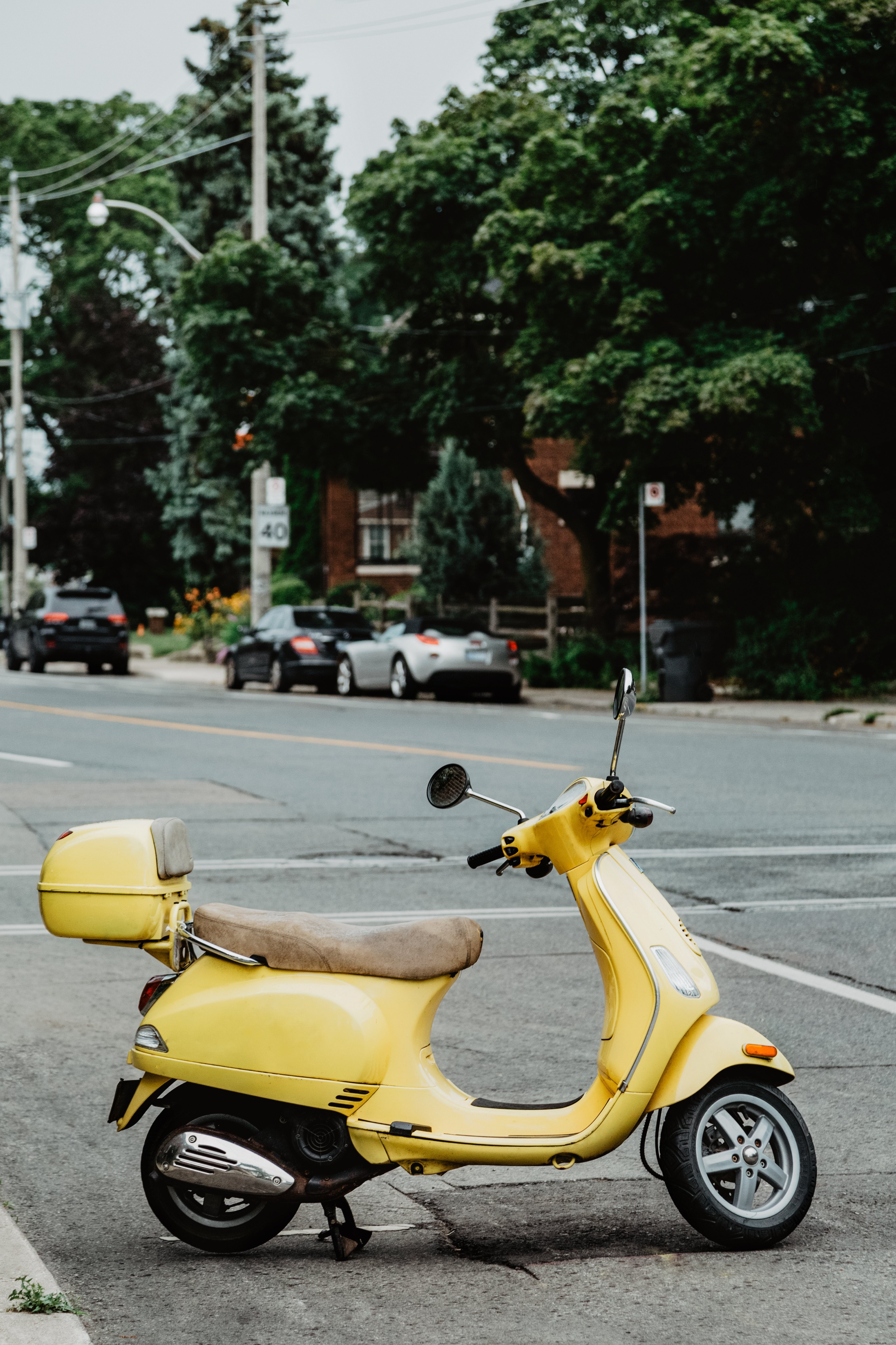 Vibrant Yellow Italian Moped Parked on Sunny Street – Stunning Photo