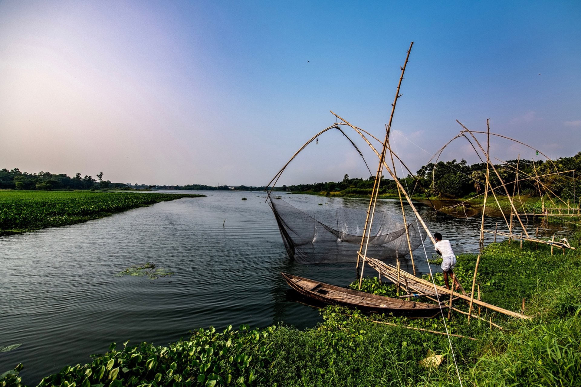 Captivating Photo: Young Fisherman Hauling in Fishing Net