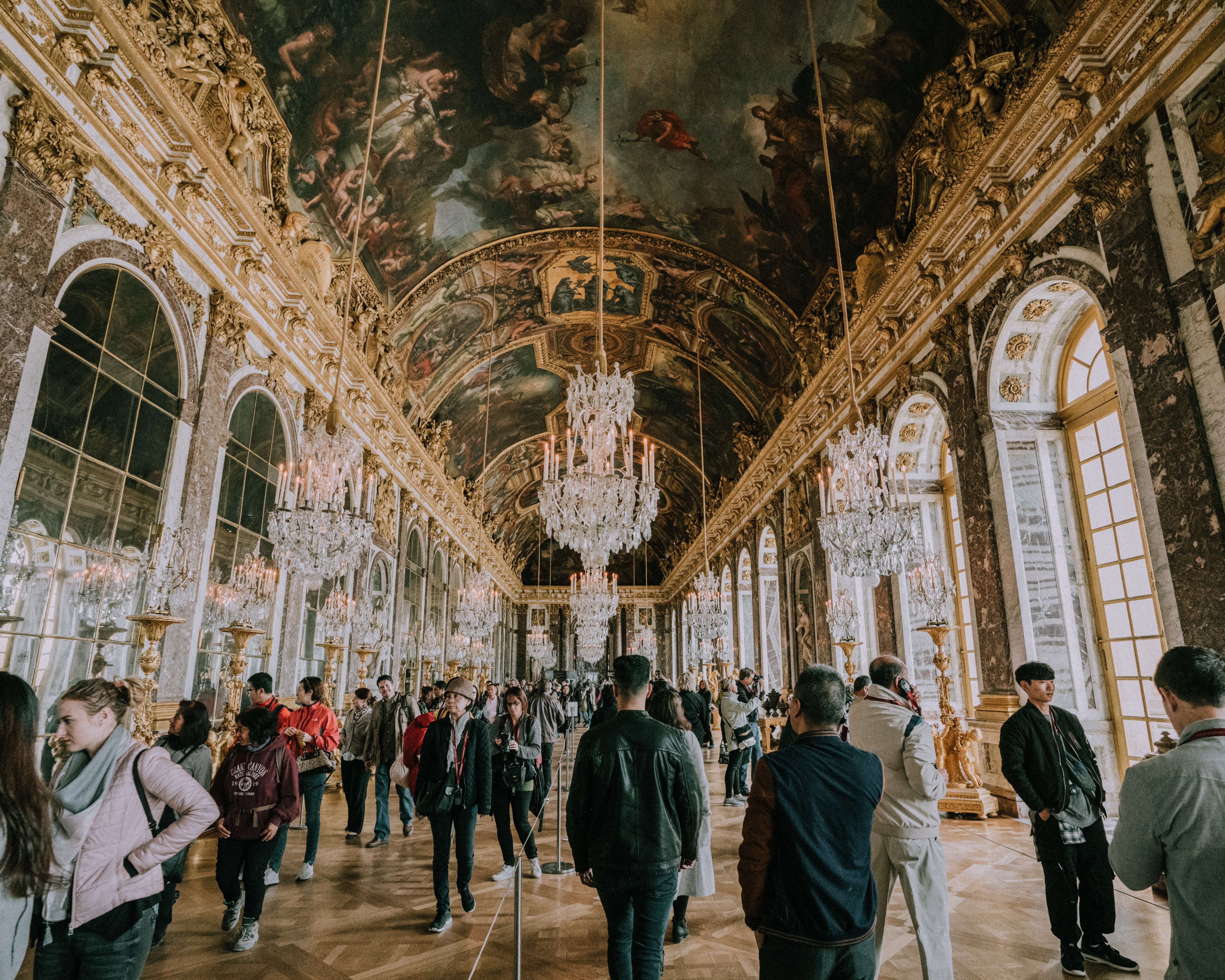 Stunning Photo: Tourists Exploring Versailles Palace Hallways