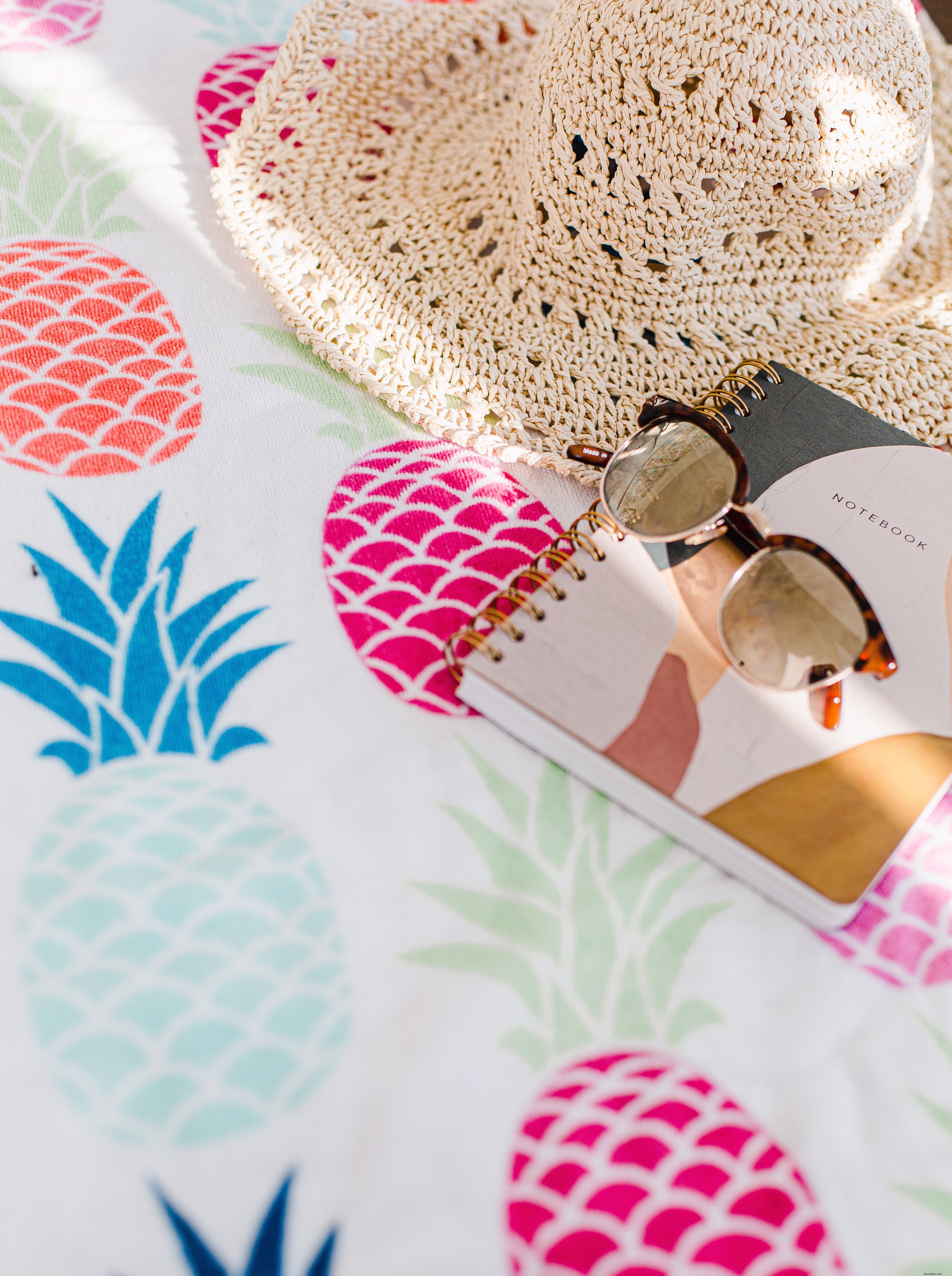 Vibrant Summer Photo: Notebook, Sunhat & Sunglasses on Pineapple Tablecloth