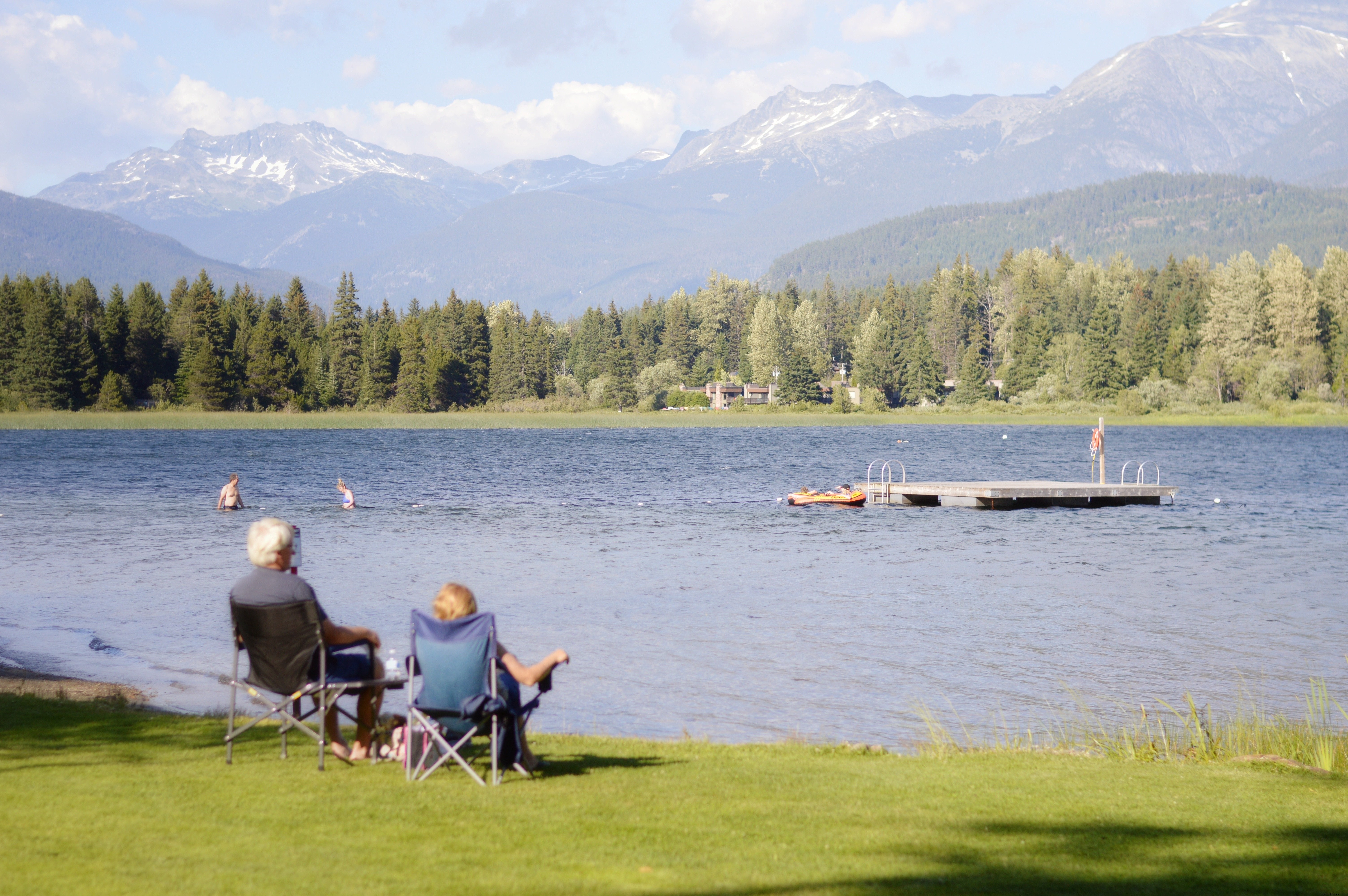 Serene Couple by the Lake: Enjoying a Peaceful Scenic View Photo