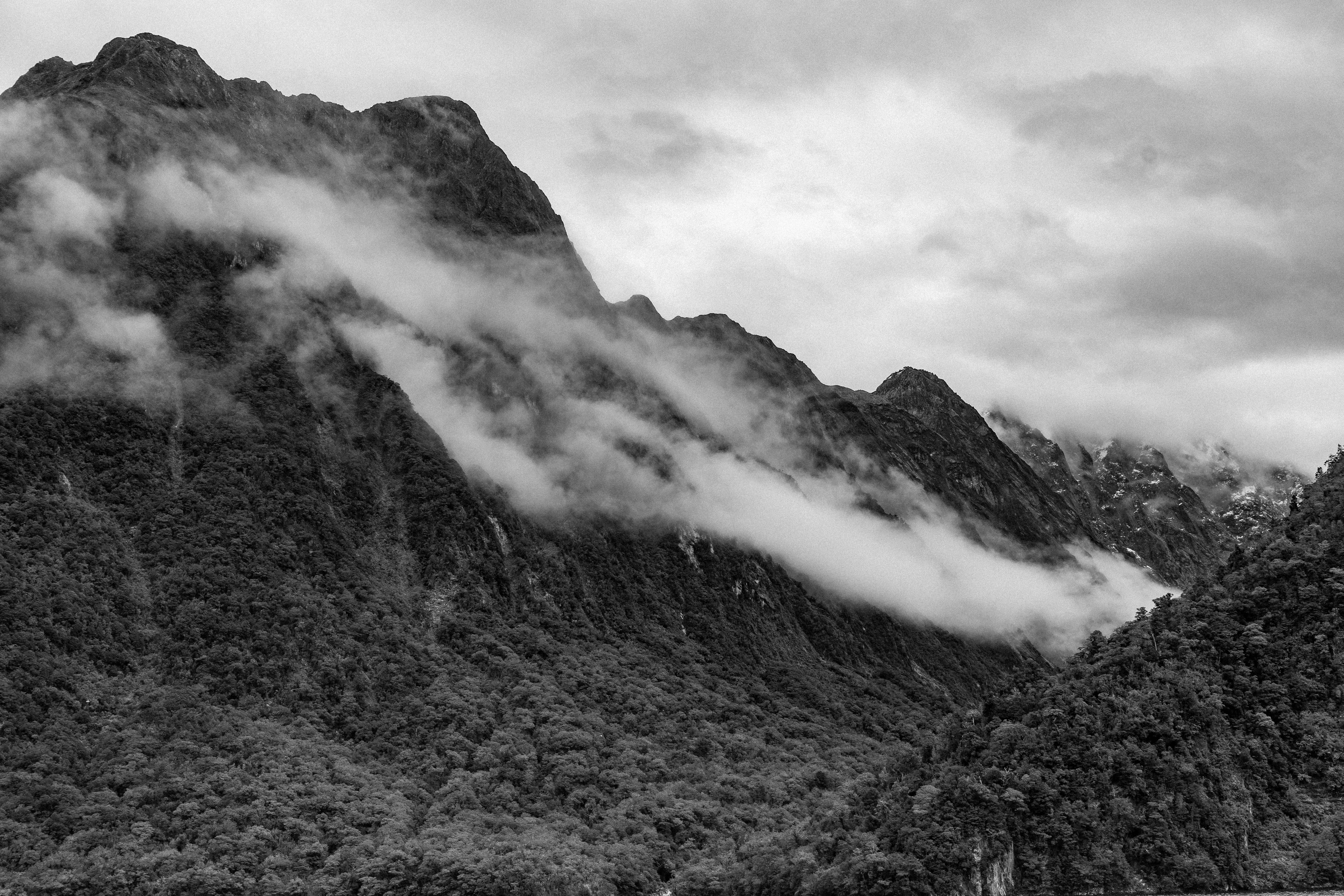 Stunning Black and White Photo: Mist Over Majestic Mountains