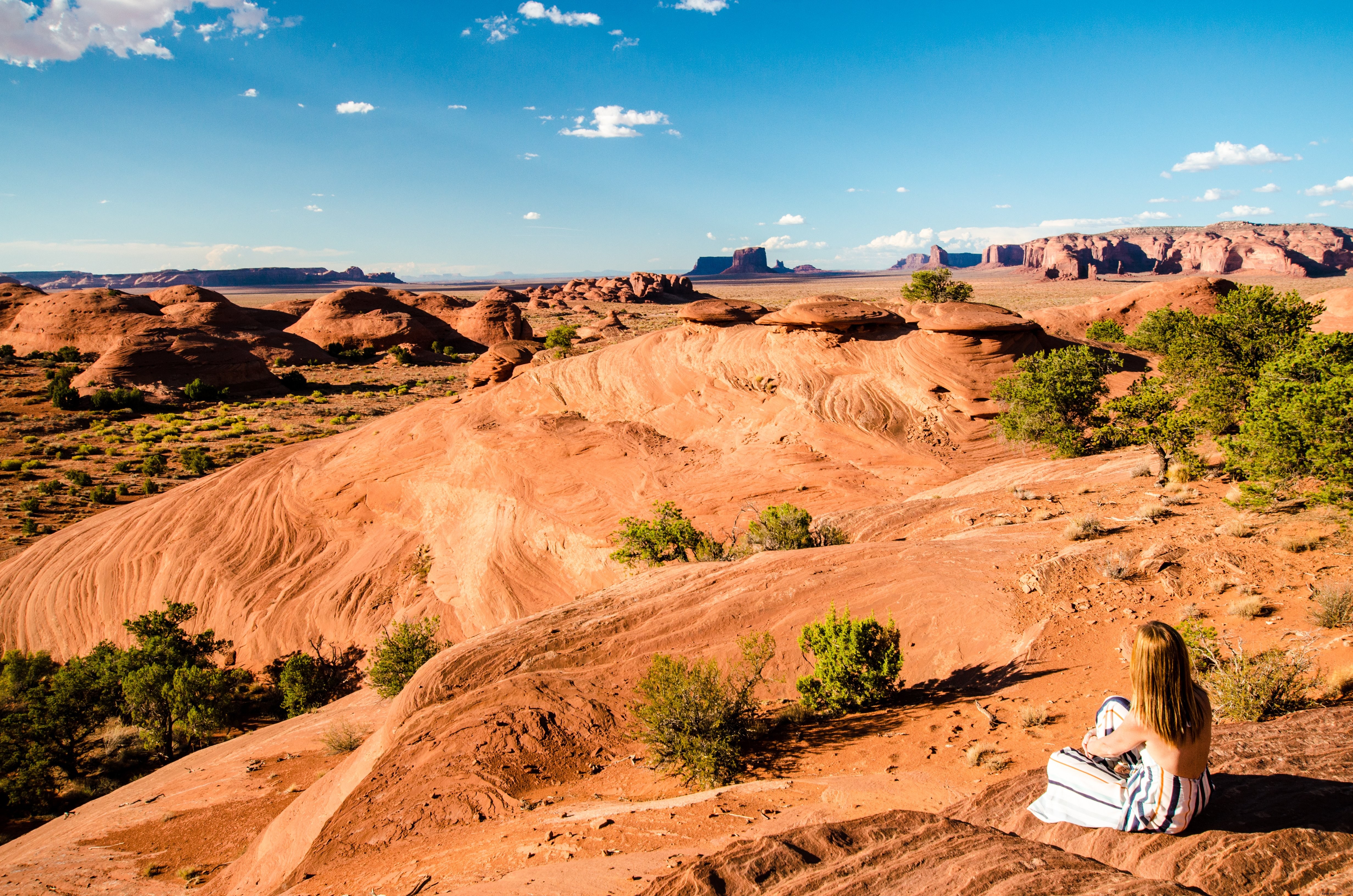 Captivating Photo: Woman on Desert Hill Overlooking Vast Mountain Plains