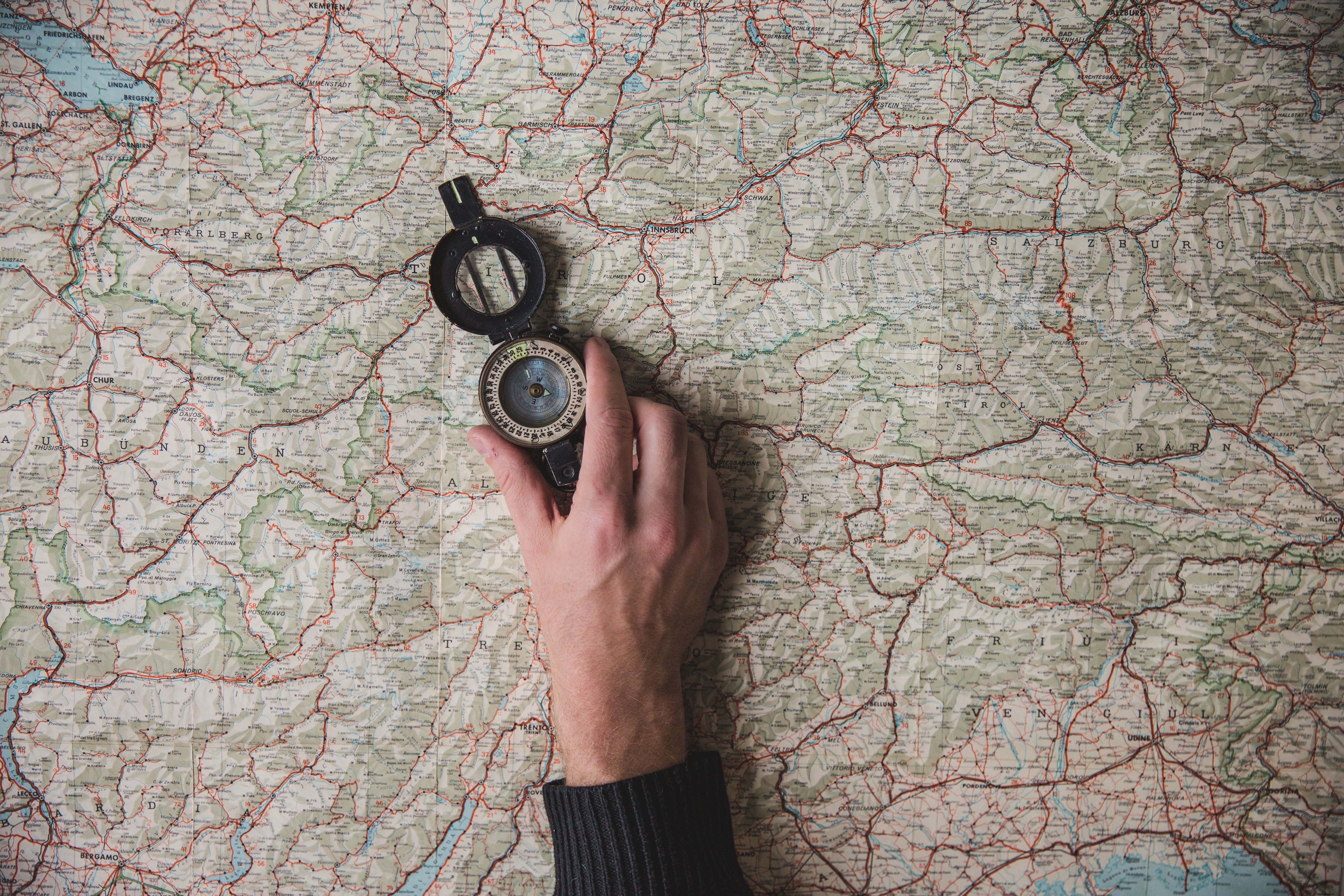 Close-Up Photo of Compass Held in Hand