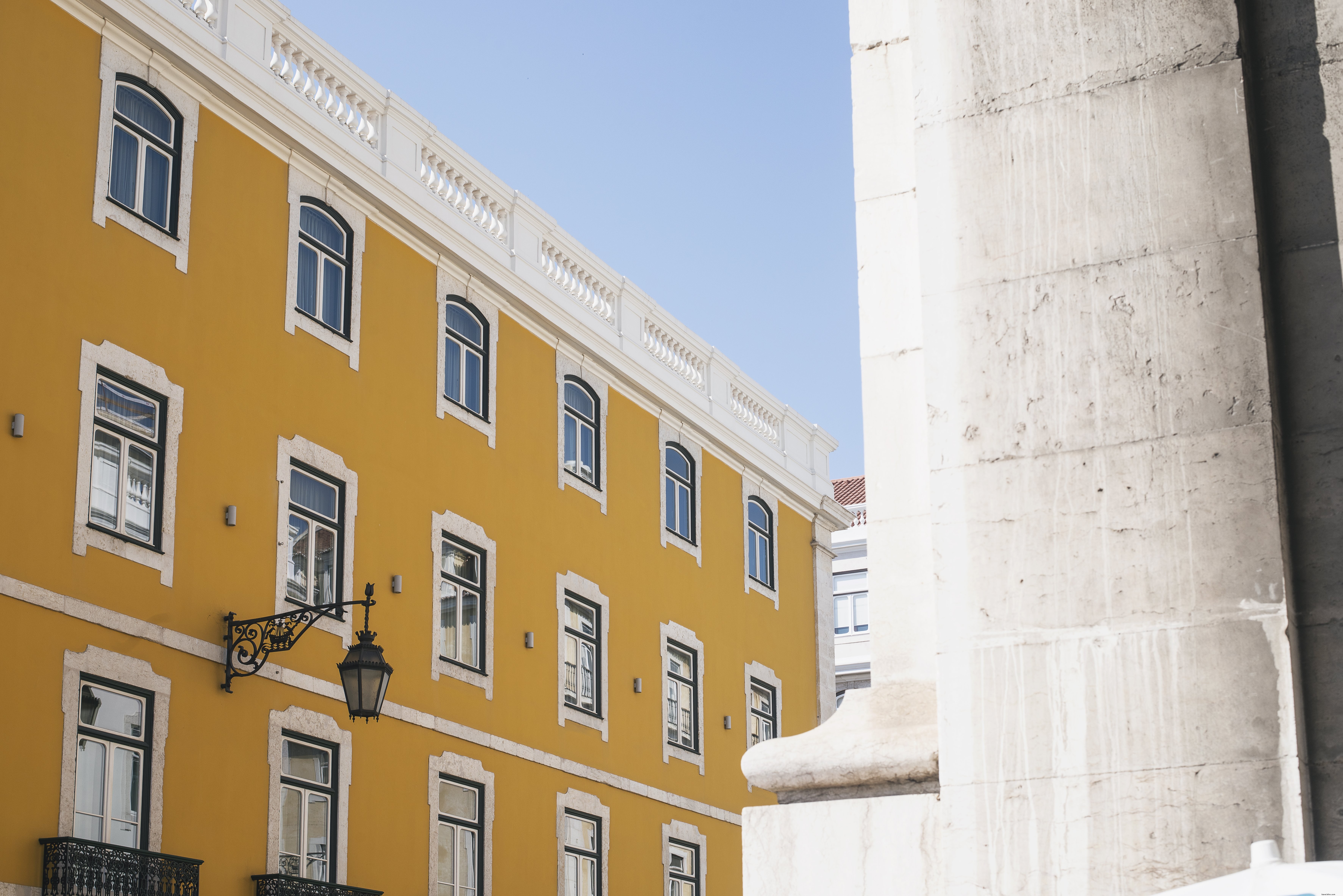 Stunning Vibrant Yellow Building Against a Crystal-Clear Blue Sky – Professional Photo