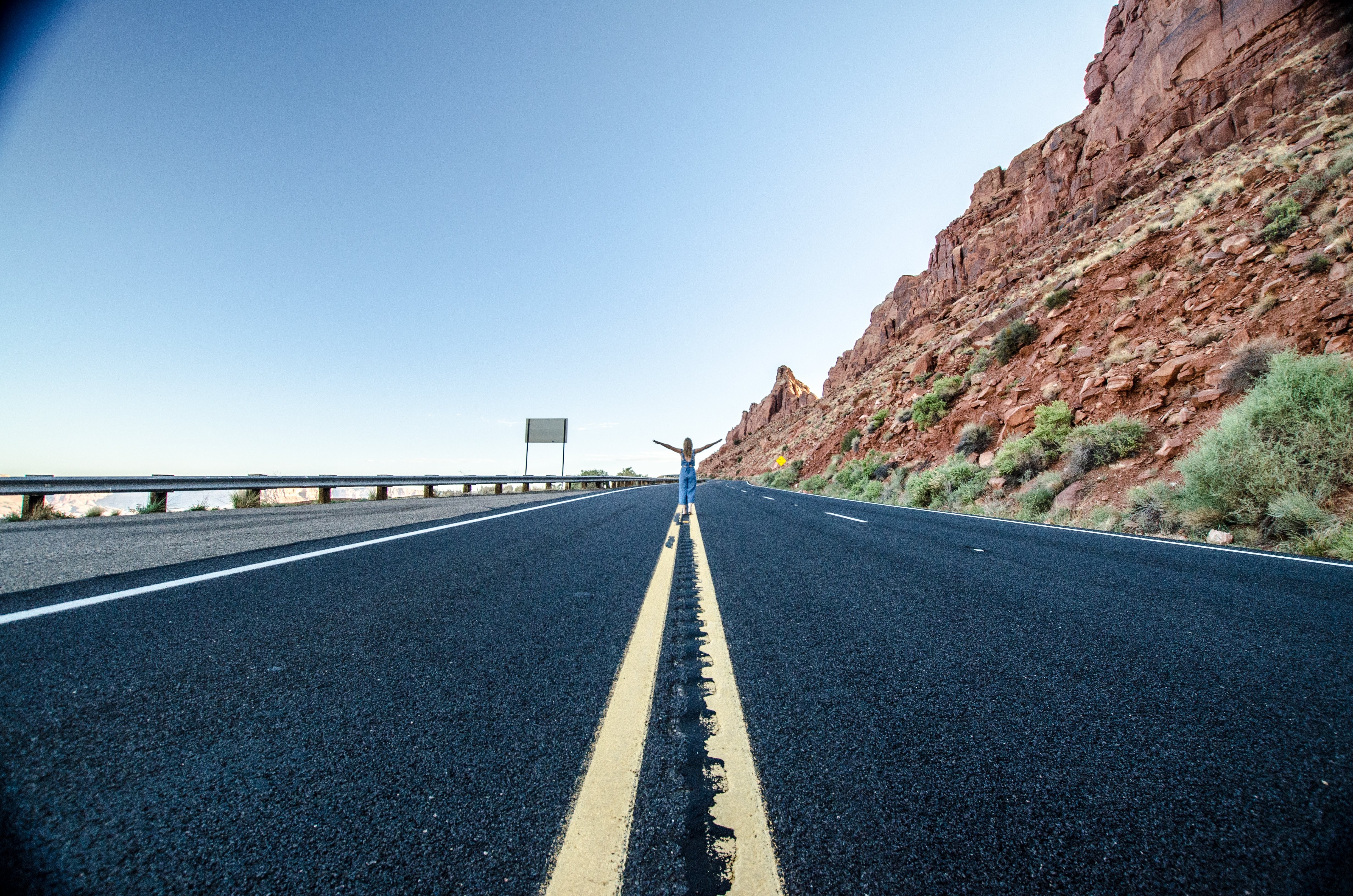 Striking Photo: Lone Woman Standing on Vast Desert Highway