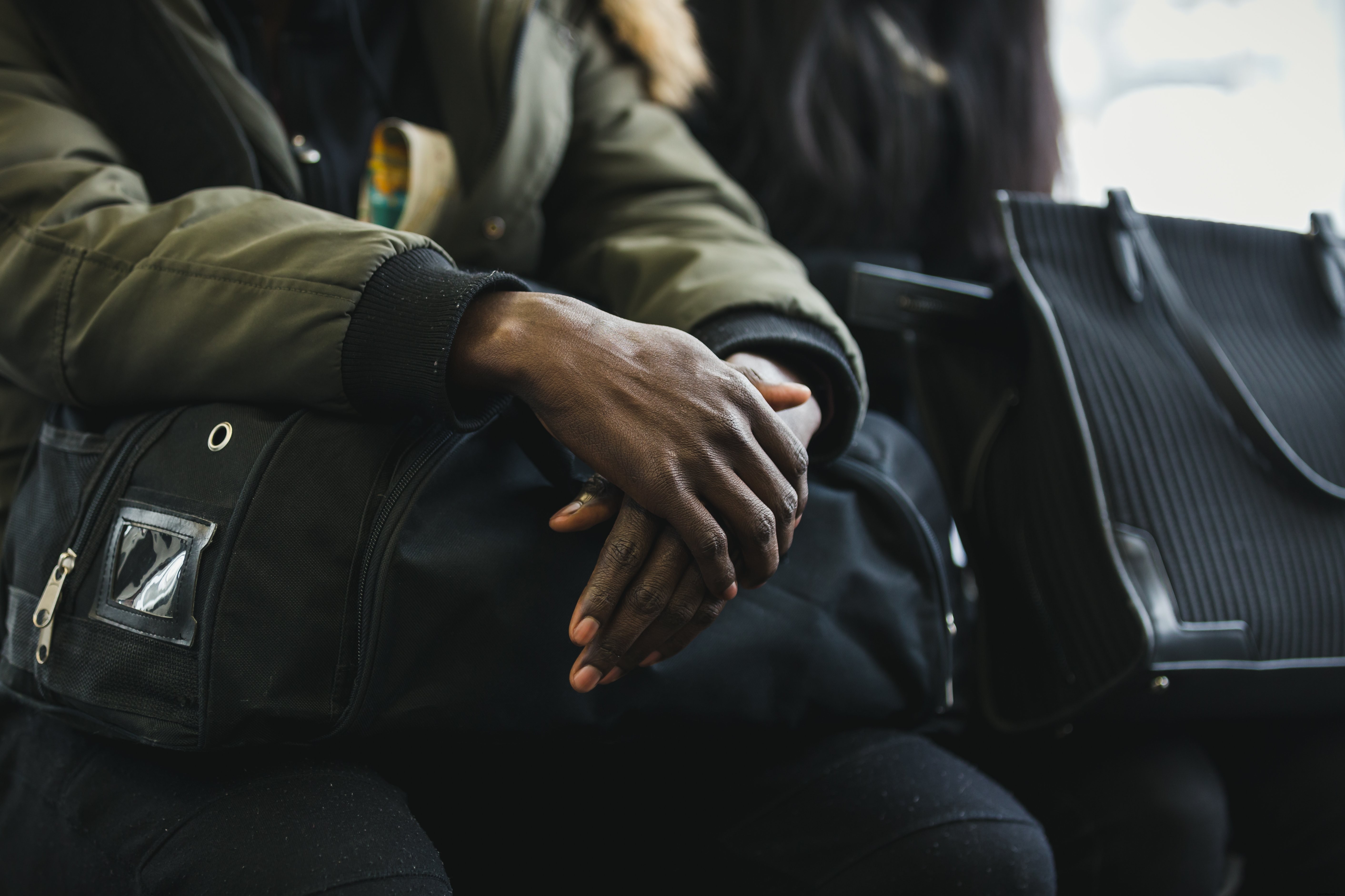 Crossed Hands in Transit: Captivating Professional Photo