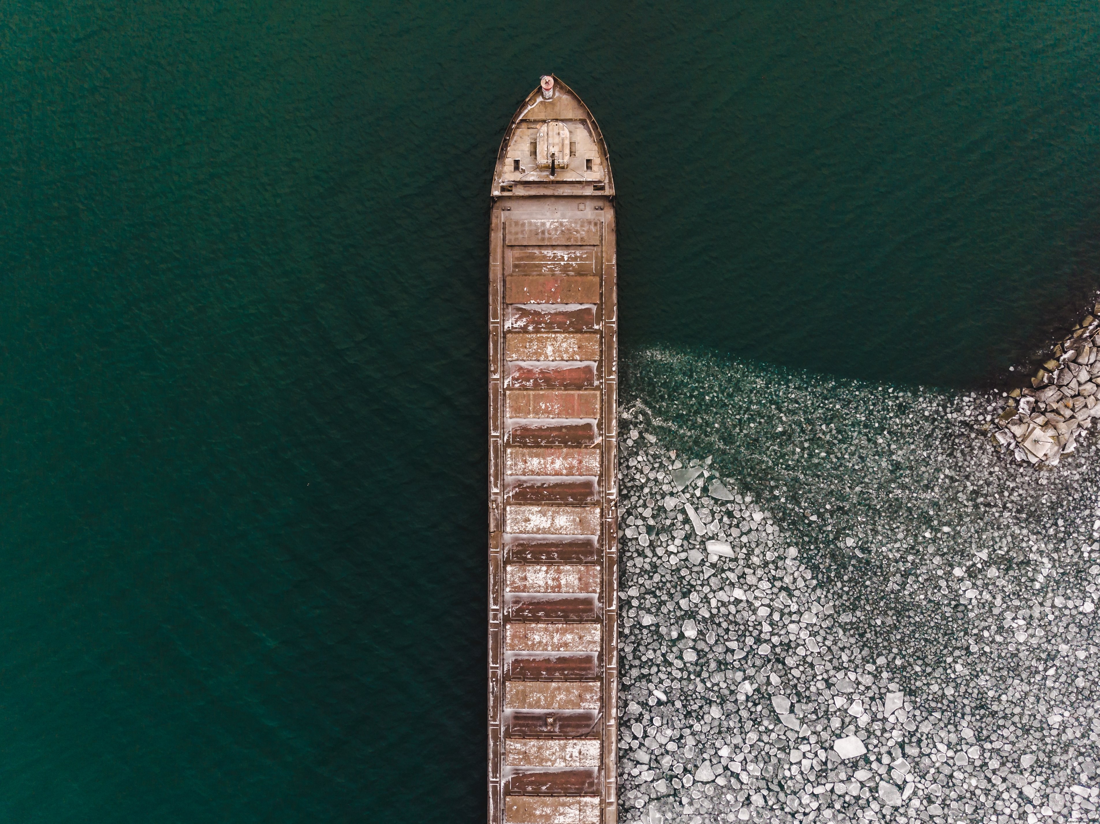 Stunning Aerial View: Boat Gliding on Icy Waters Photo