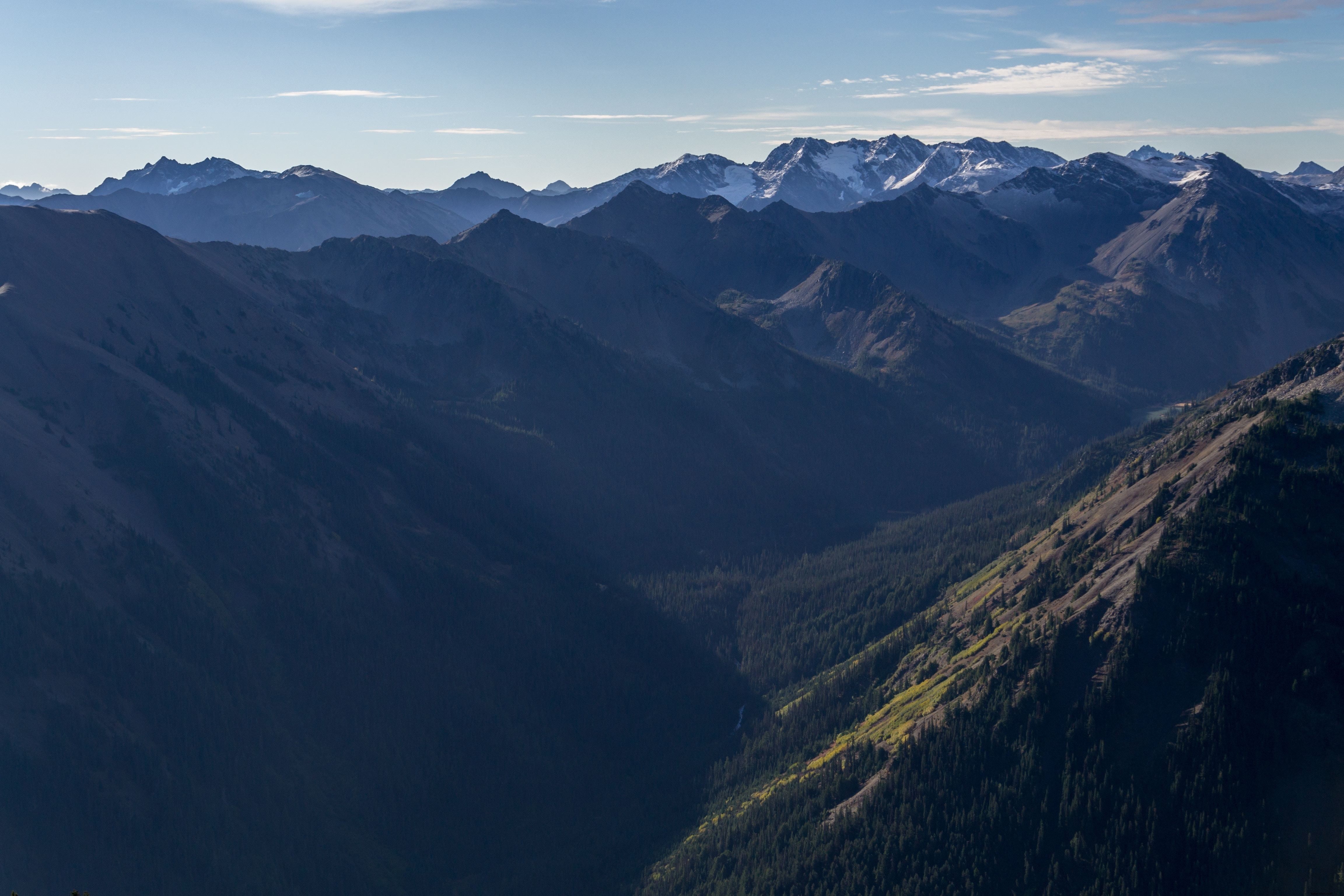 Stunning Photo: Sunlight Dancing Across Majestic Mountain Peaks