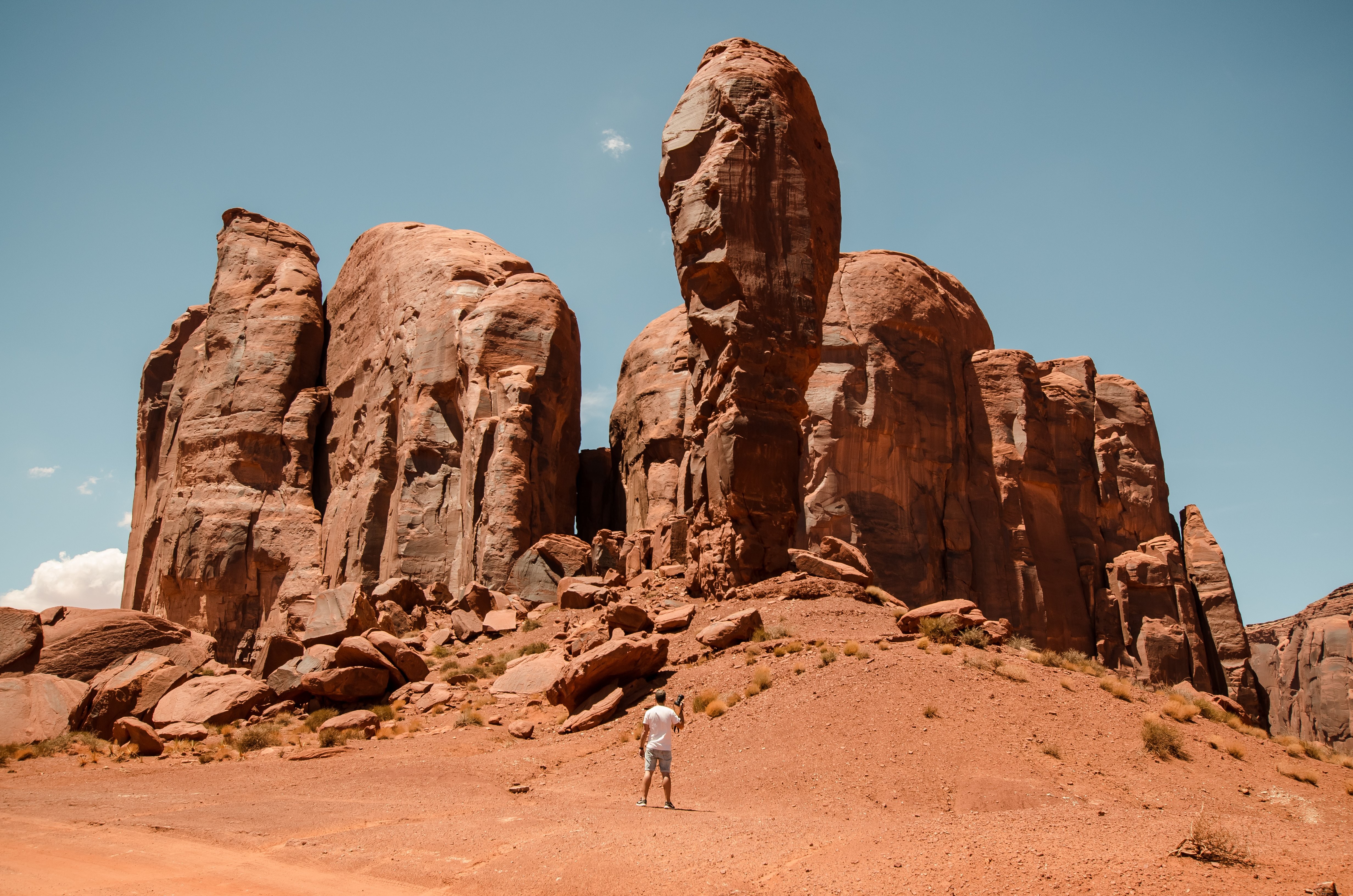 Lone Photographer Dwarfed by Towering Red Desert Pillars – Epic Landscape Photo