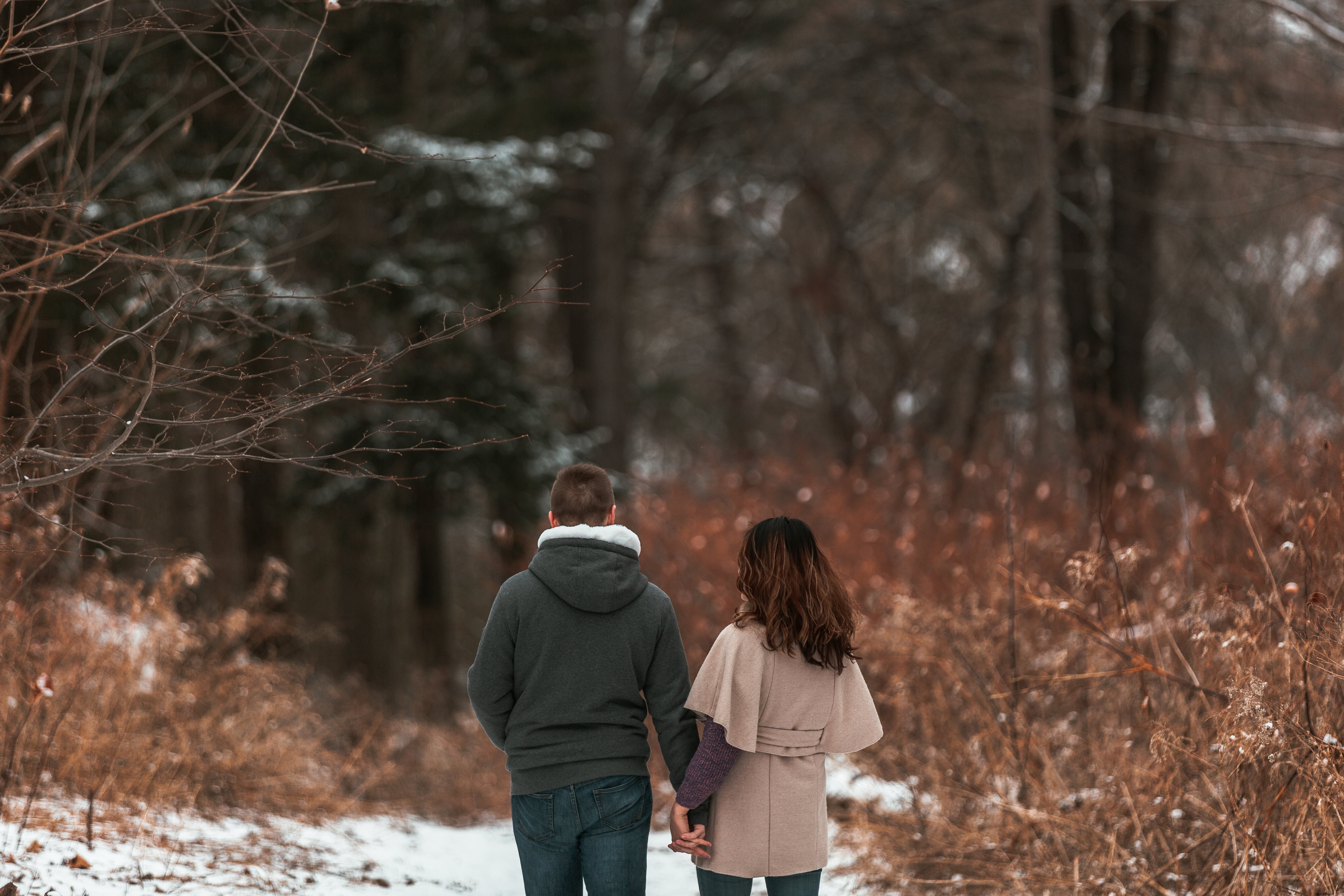 Intimate Close-Up: Romantic Couple Strolling Hand-in-Hand in Snowy Winter Wonderland