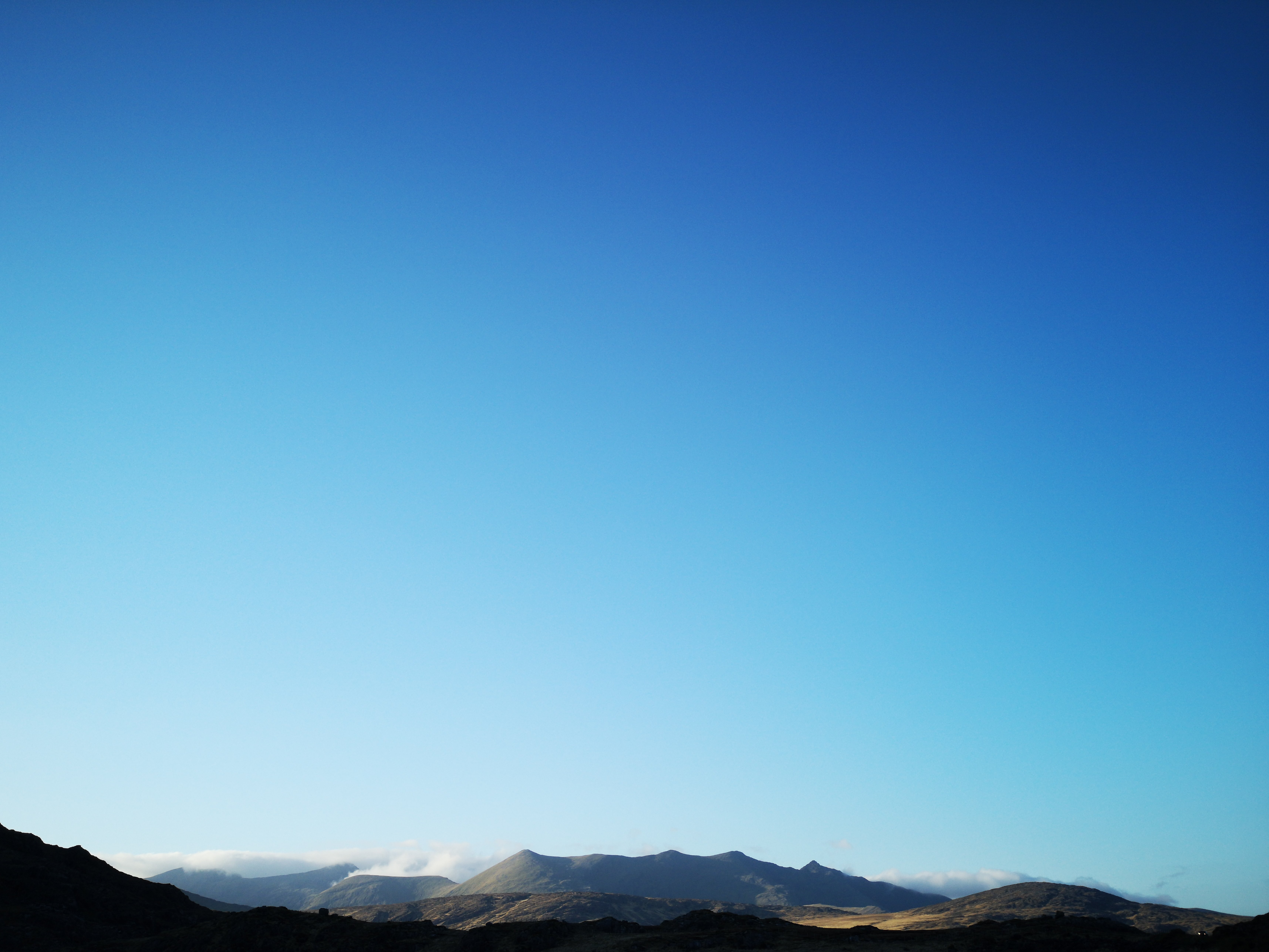 Stunning Blue Sky Over Sunlit Mountains – Breathtaking Landscape Photo
