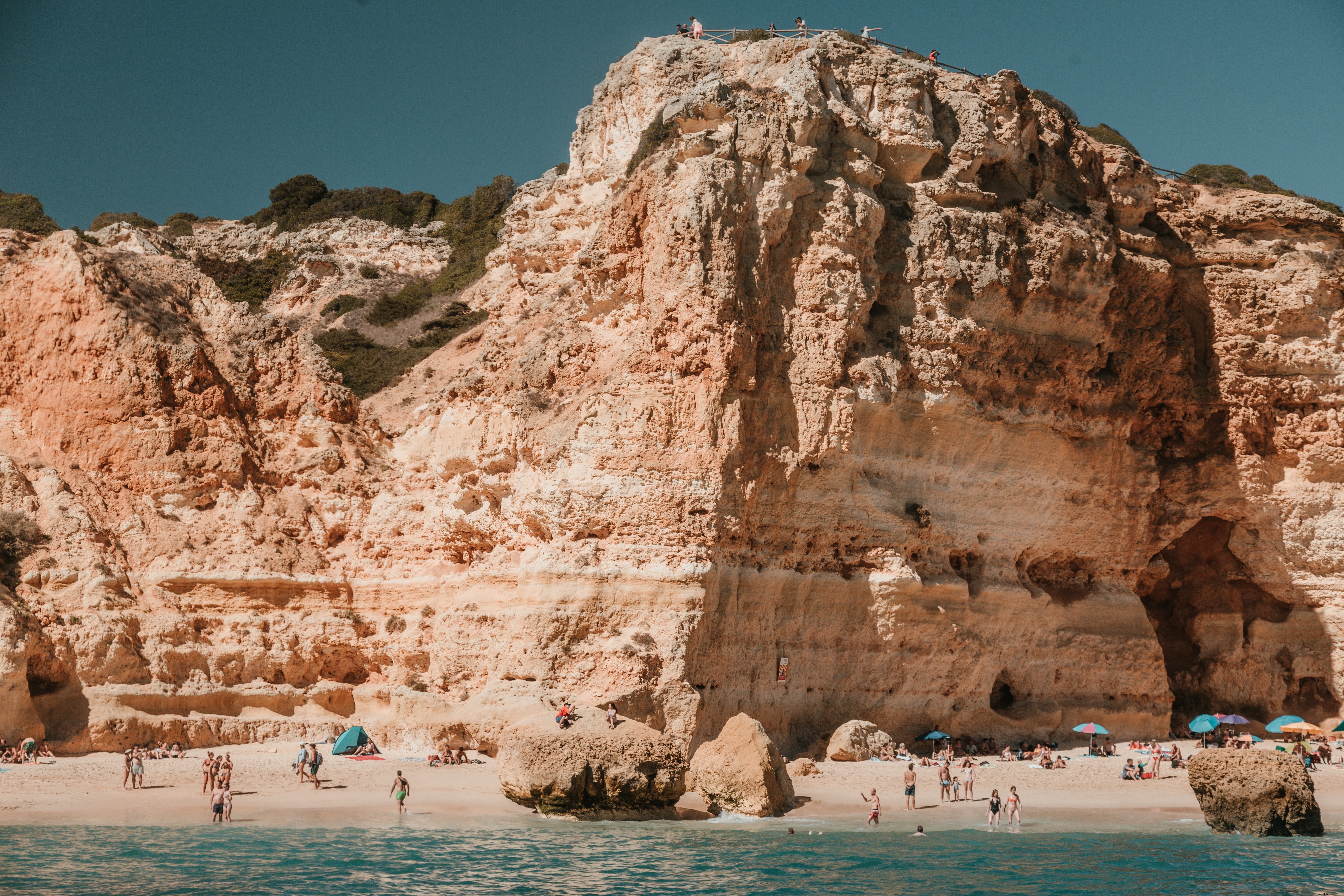 Majestic Rocky Limestone Cliffs Towering Over Pristine Sandy Beach – Stunning Photo