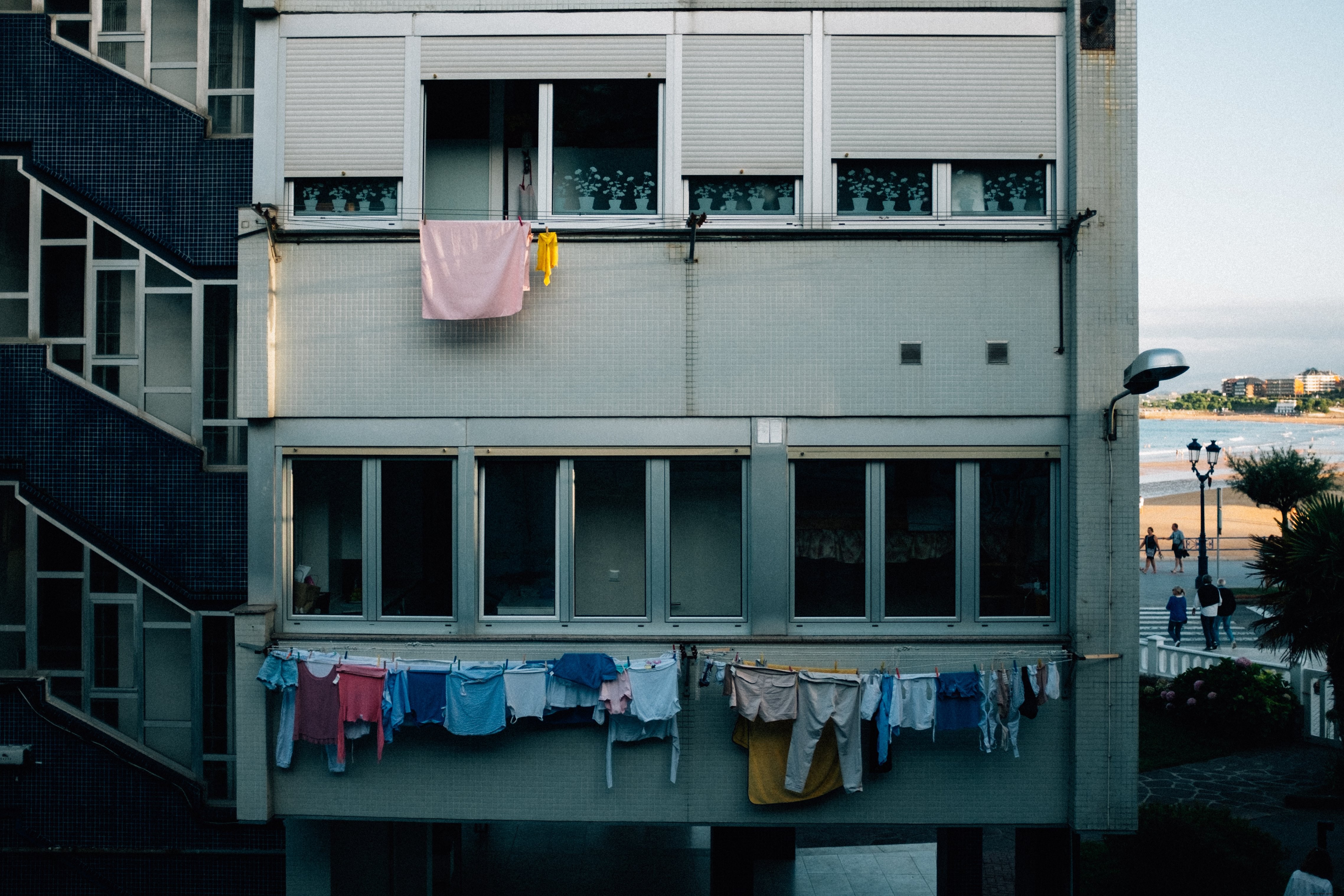 Grey Apartment Facade Adorned with Clotheslines – Striking Urban Photo