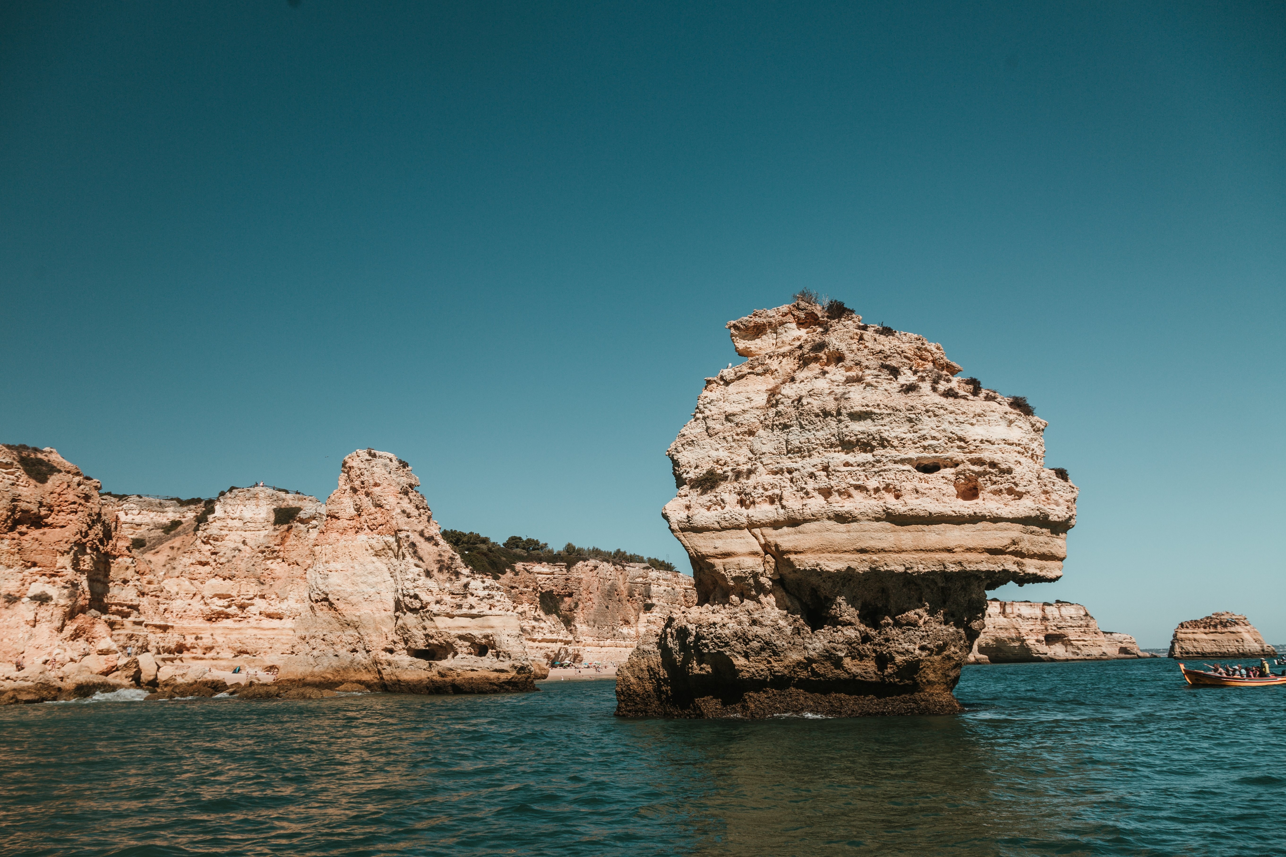 Majestic Sea Stack Rising from Crystal Blue Waters – Stunning Photo