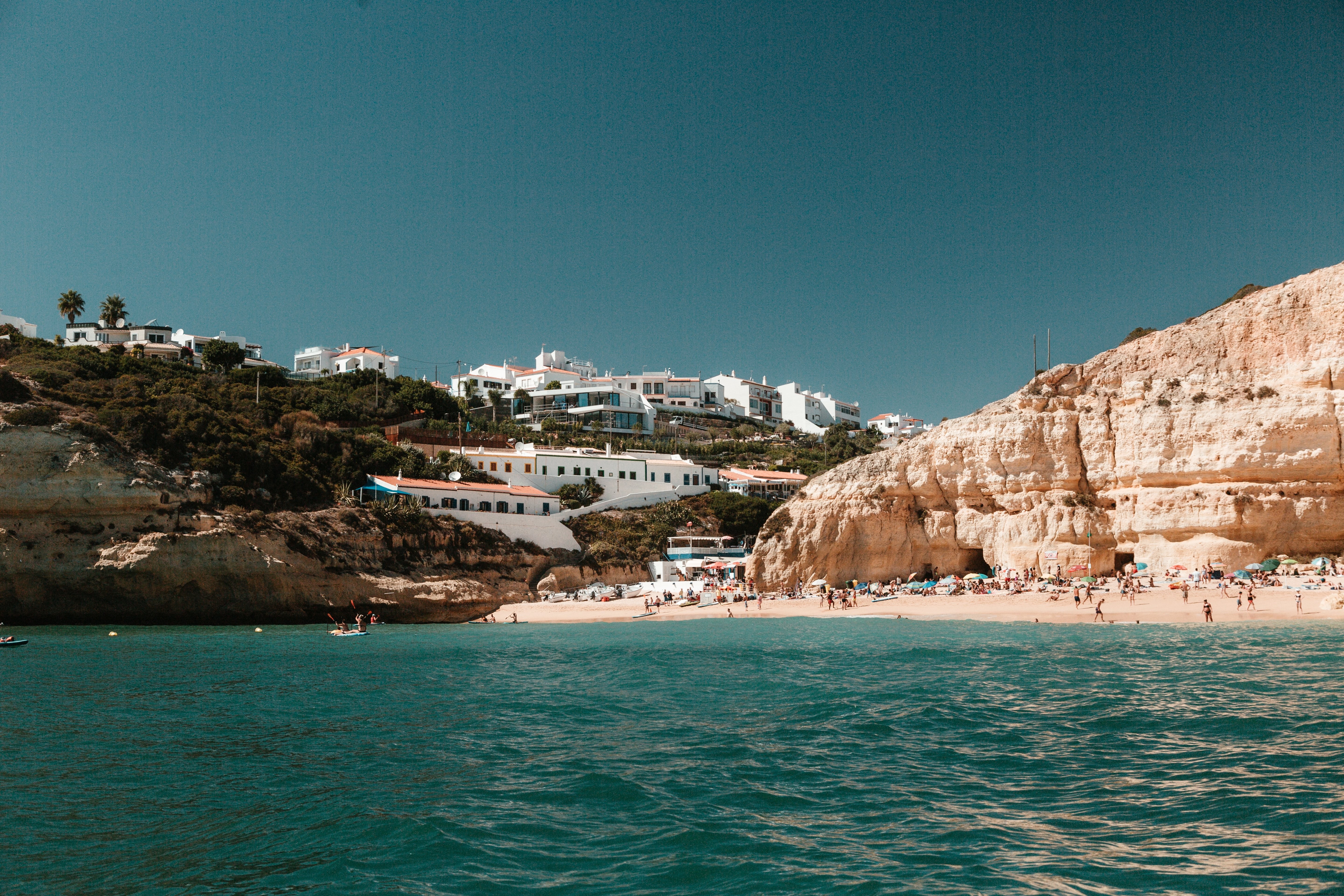 Stunning Photo: Limestone Hills Dotted with Houses Overlooking Pristine Sandy Beach