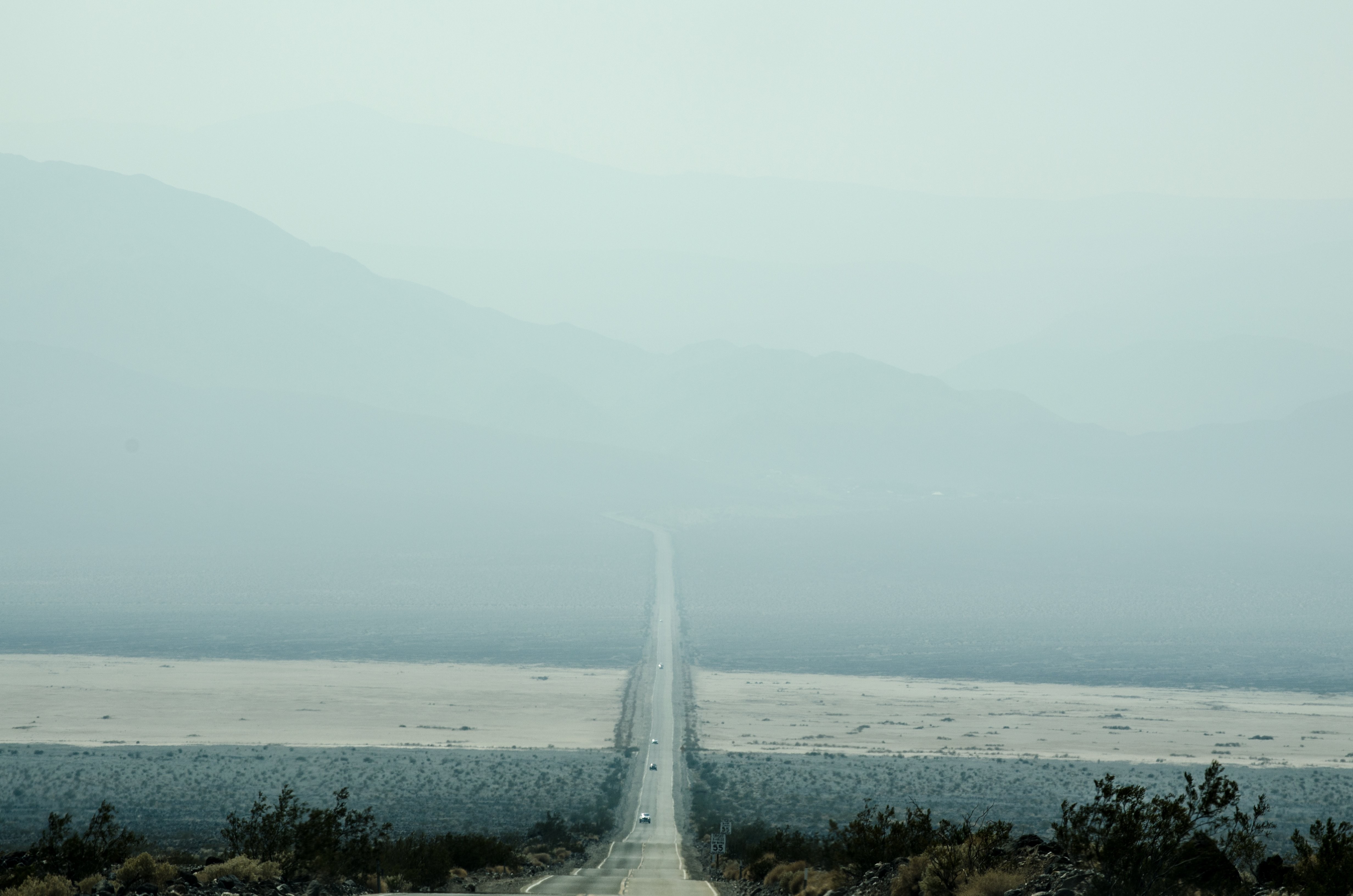 Scenic Drive Beneath Majestic Misty Mountains – Stunning Photo