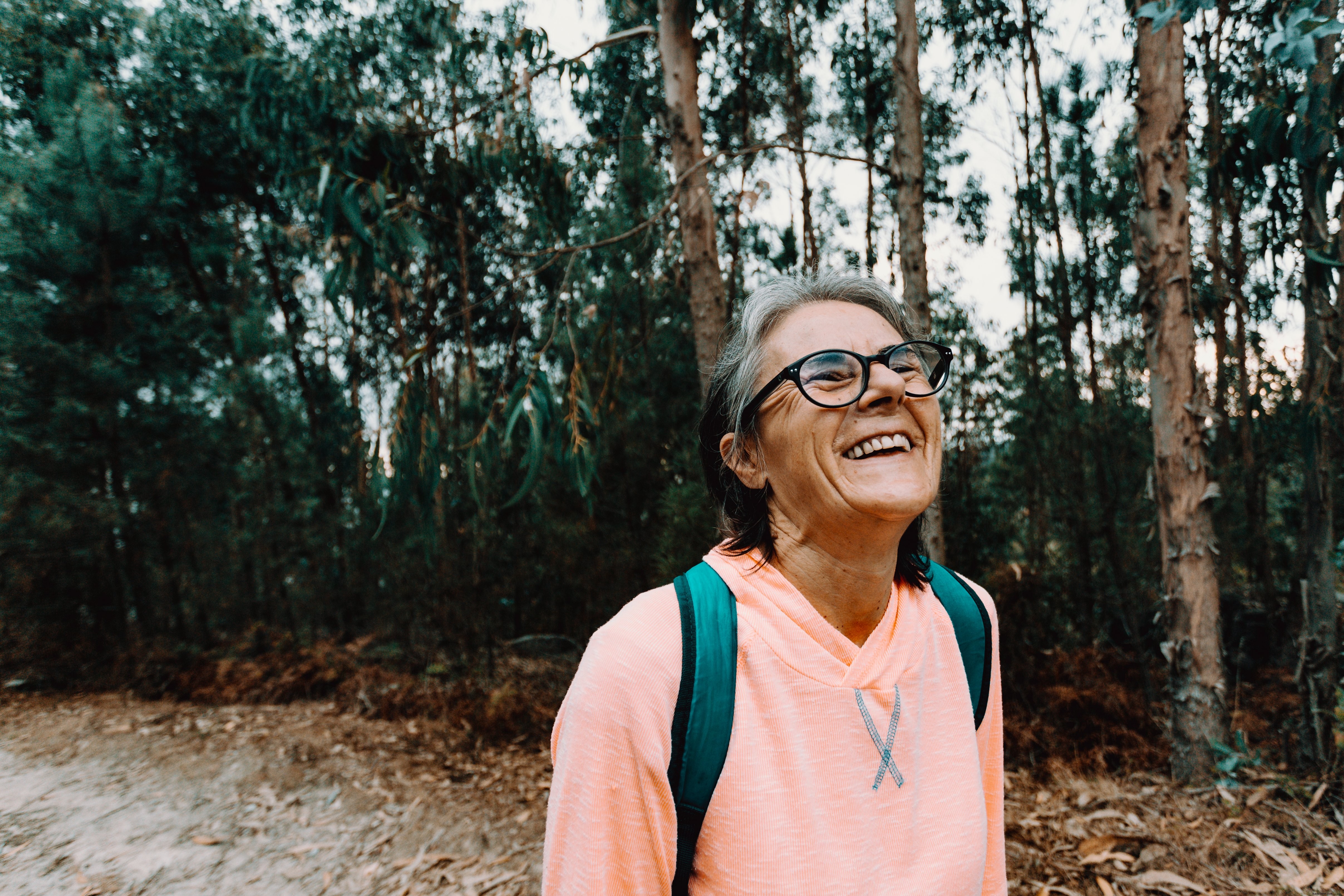 Radiant Outdoor Portrait: Woman Tilts Head Back in Joyful Smile