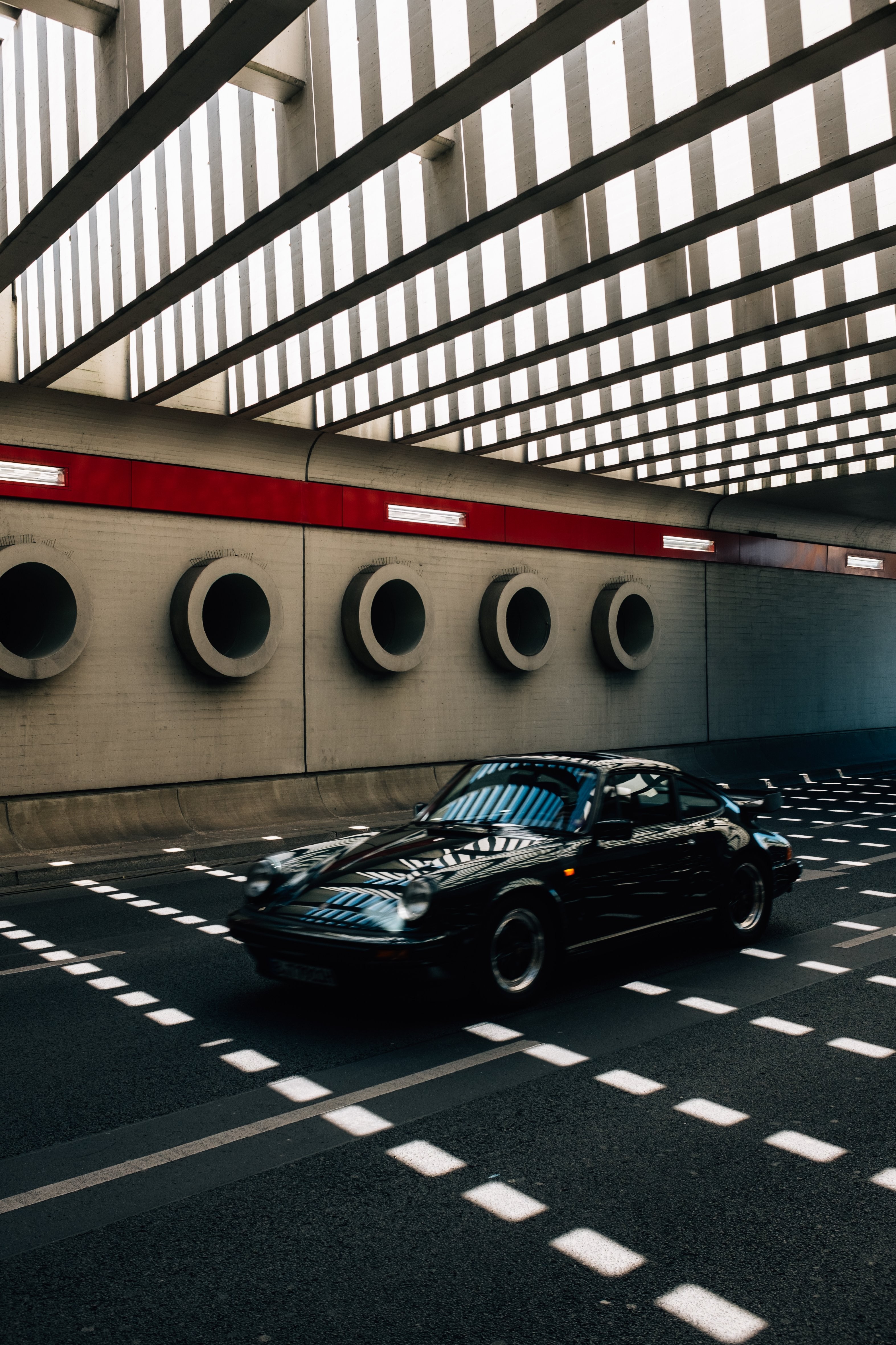 Vintage Classic Car Speeds Through Modern Tunnel – Stunning Action Photo