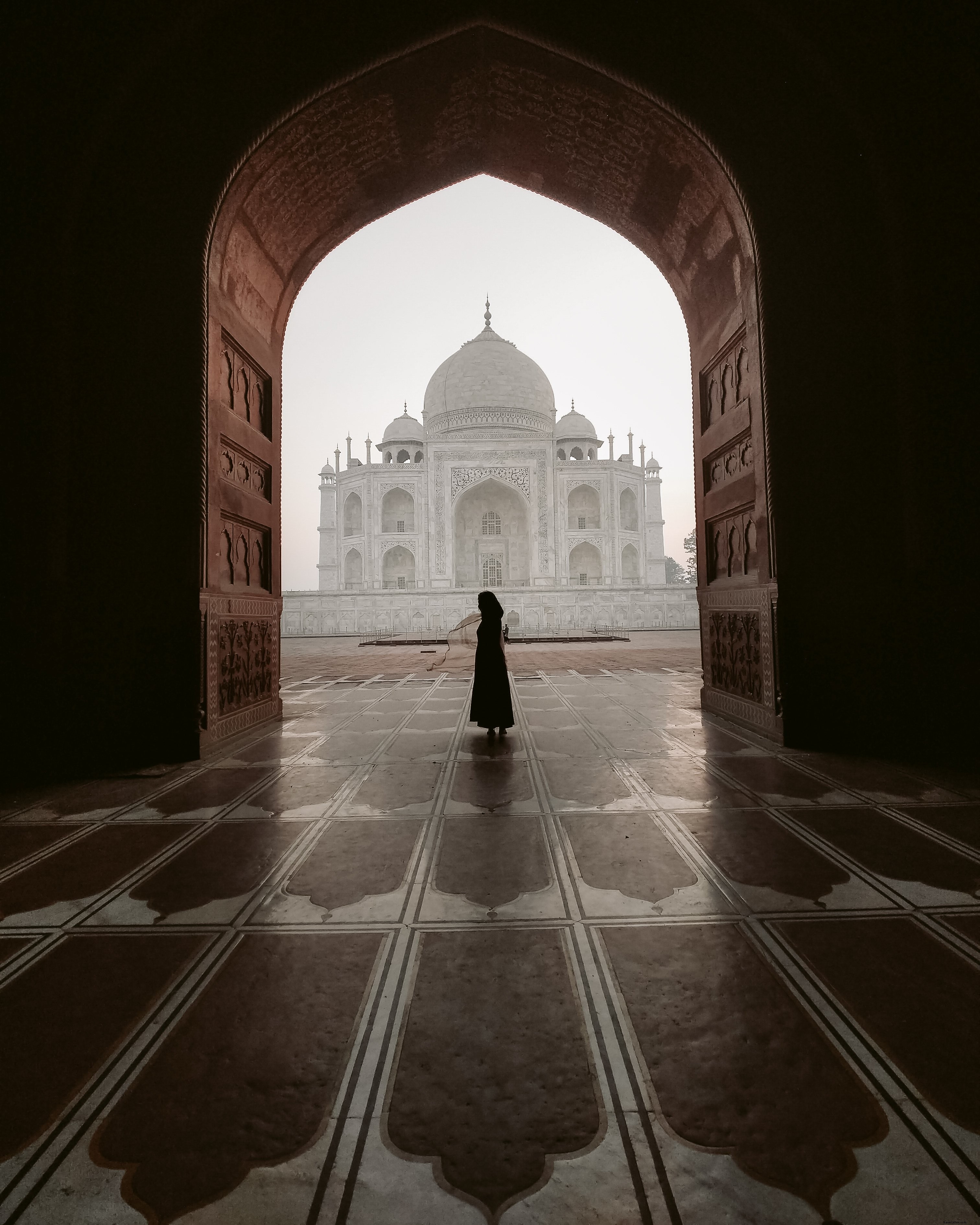 Dramatic Silhouette: Figure in Ancient Carved Archway – Stunning Photography