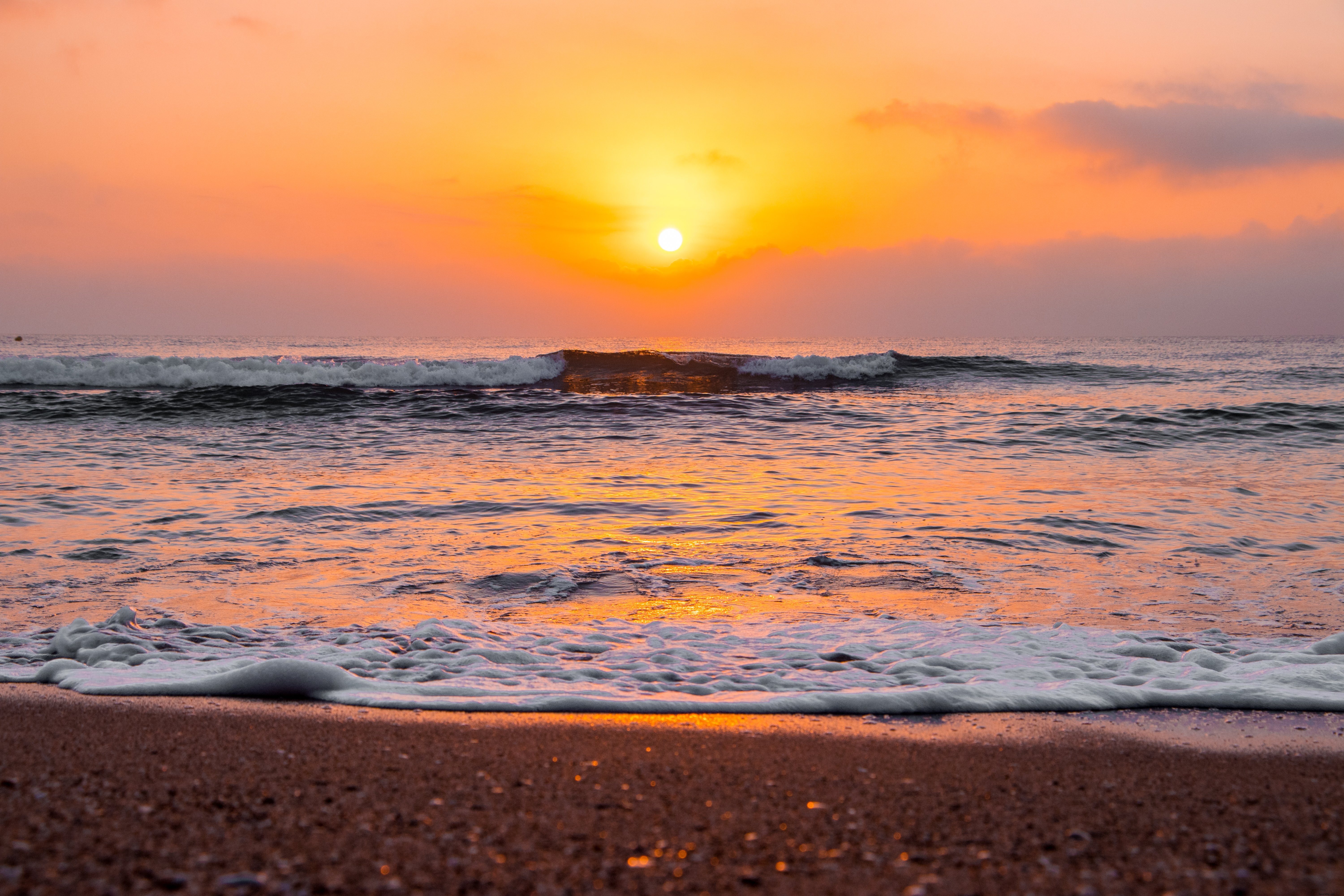 Stunning Sunrise Over Wavy Ocean Waves on Sandy Beach – Professional Photo