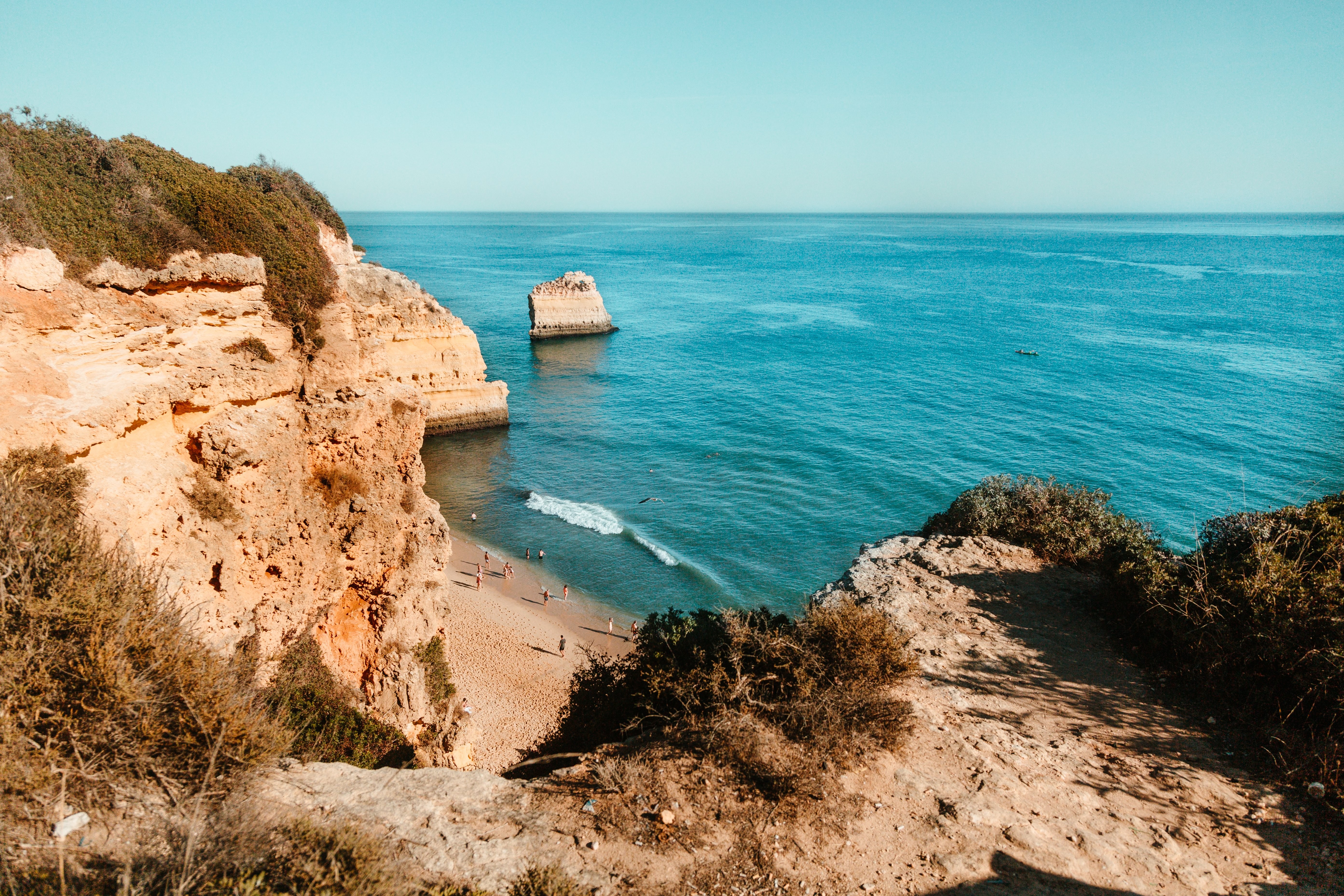 Stunning Golden Beach Nestled Beneath Dramatic Cliffs – Breathtaking Photo
