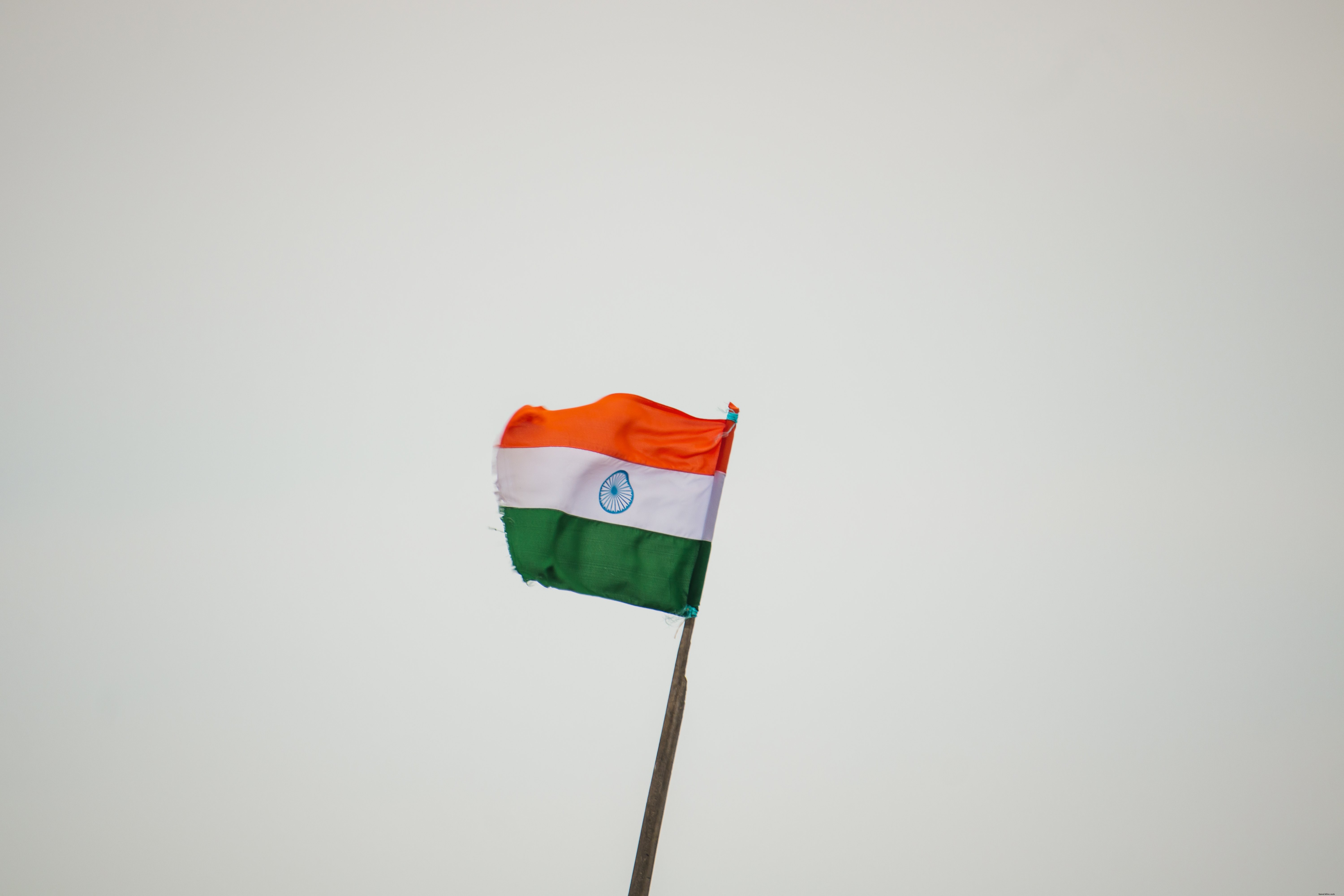 Indian Flag Waving Boldly Against a Dramatic Overcast Sky – Stunning Photo