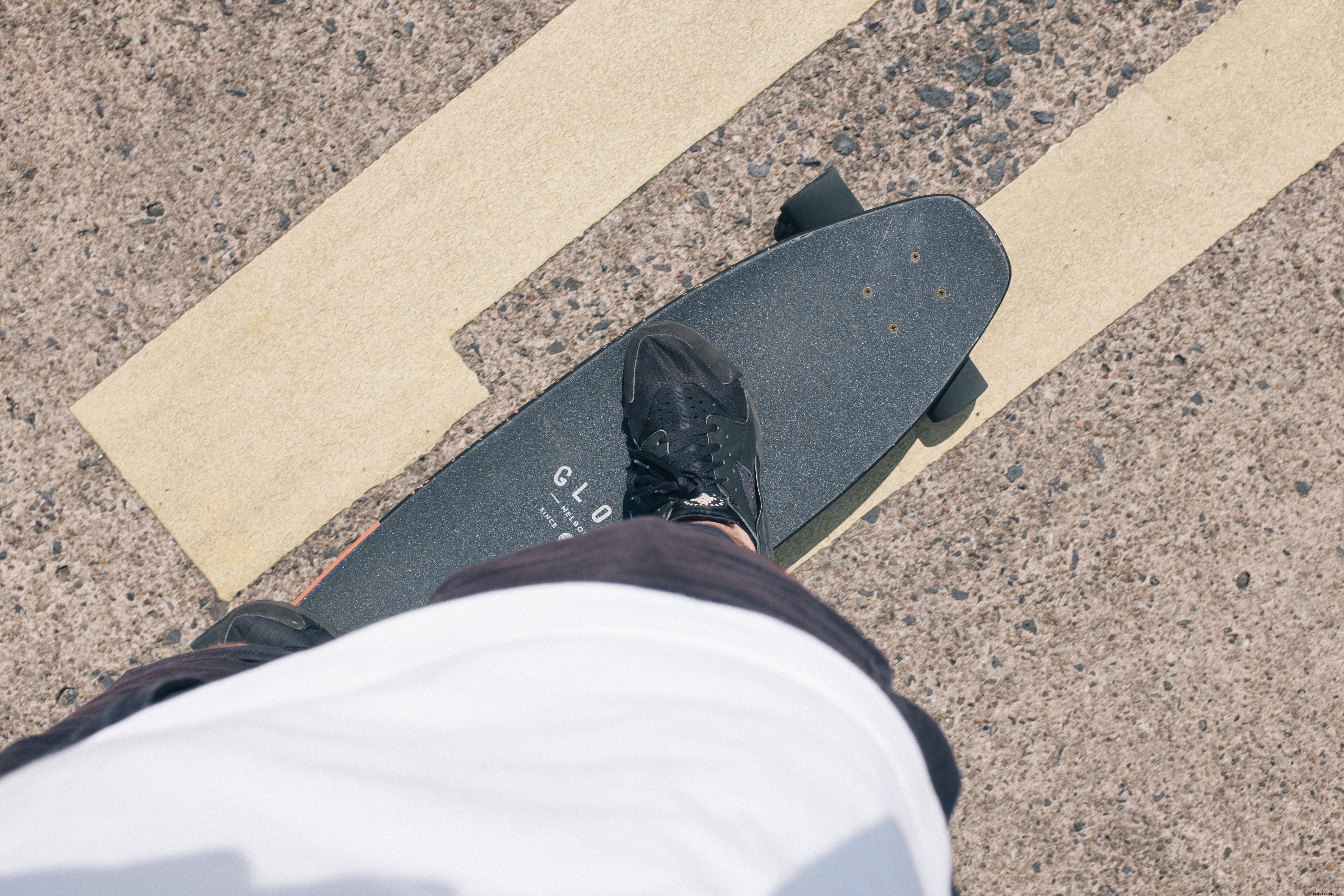 Dynamic Photo: Person Balancing on Black Skateboard on Smooth Paved Road