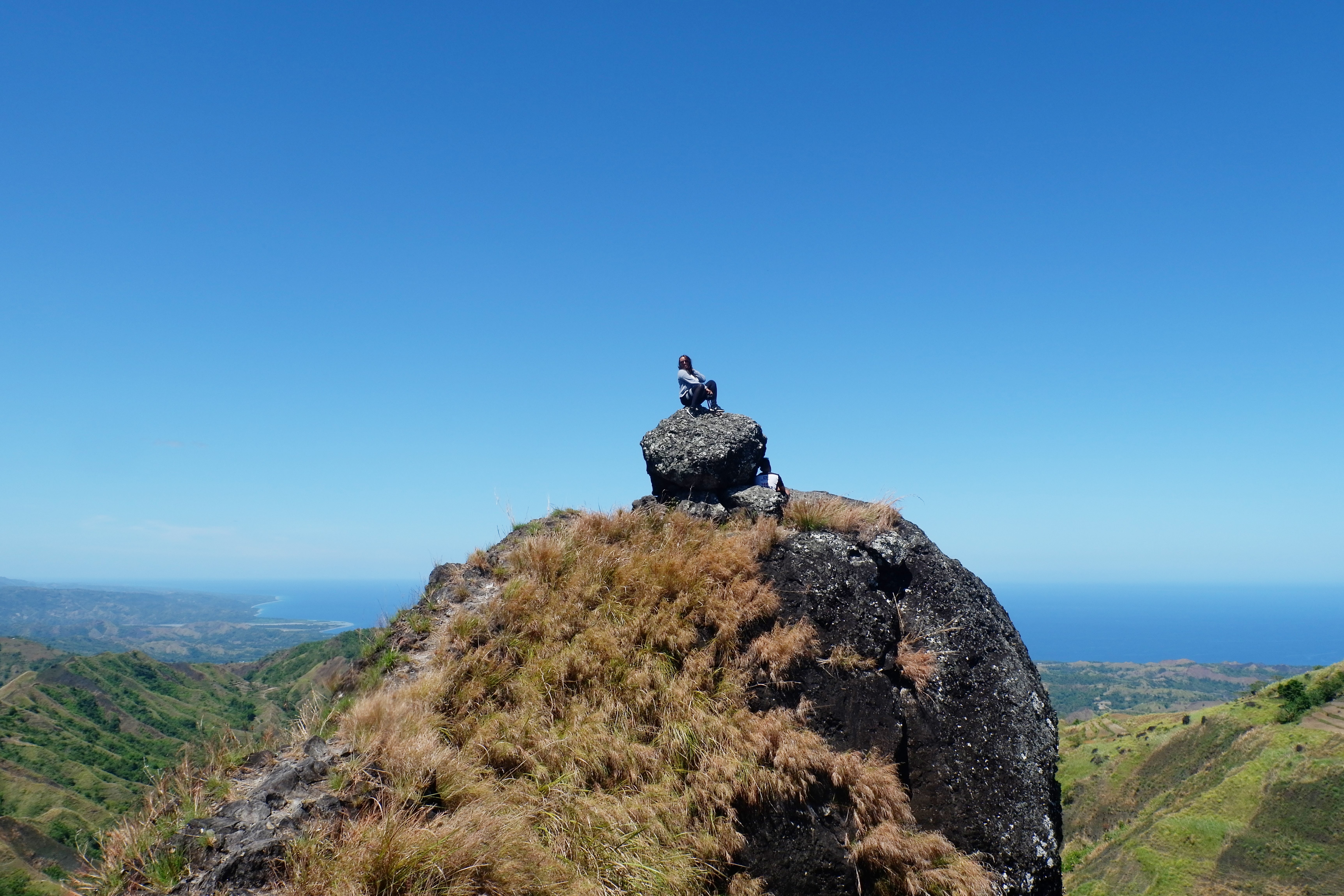 Breathtaking Photo: Hiker Resting on Rock Overlooking Stunning Landscape