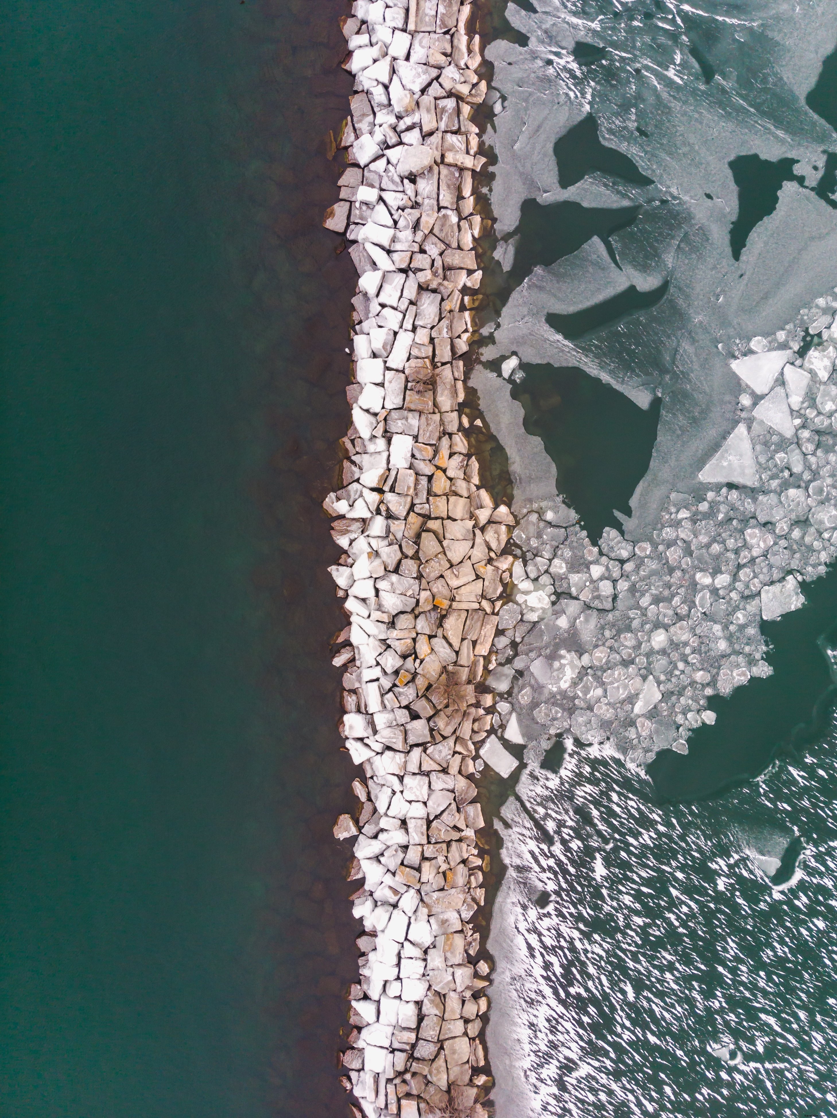 Stunning Photo: Rocks Dividing Crystal Clear Water and Ice