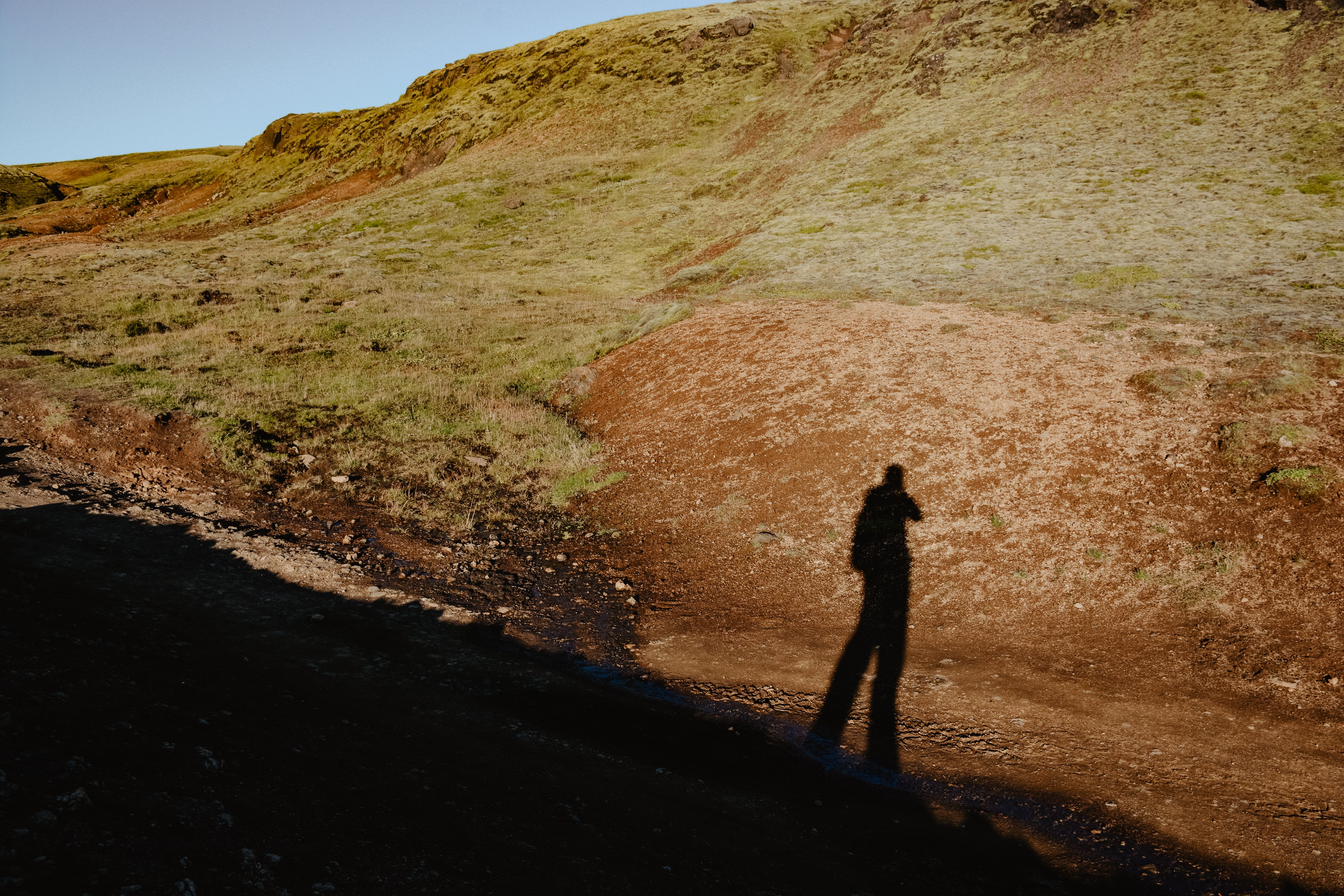 Dramatic Hiker Shadow on Scenic Hilltop – Stunning Outdoor Photo