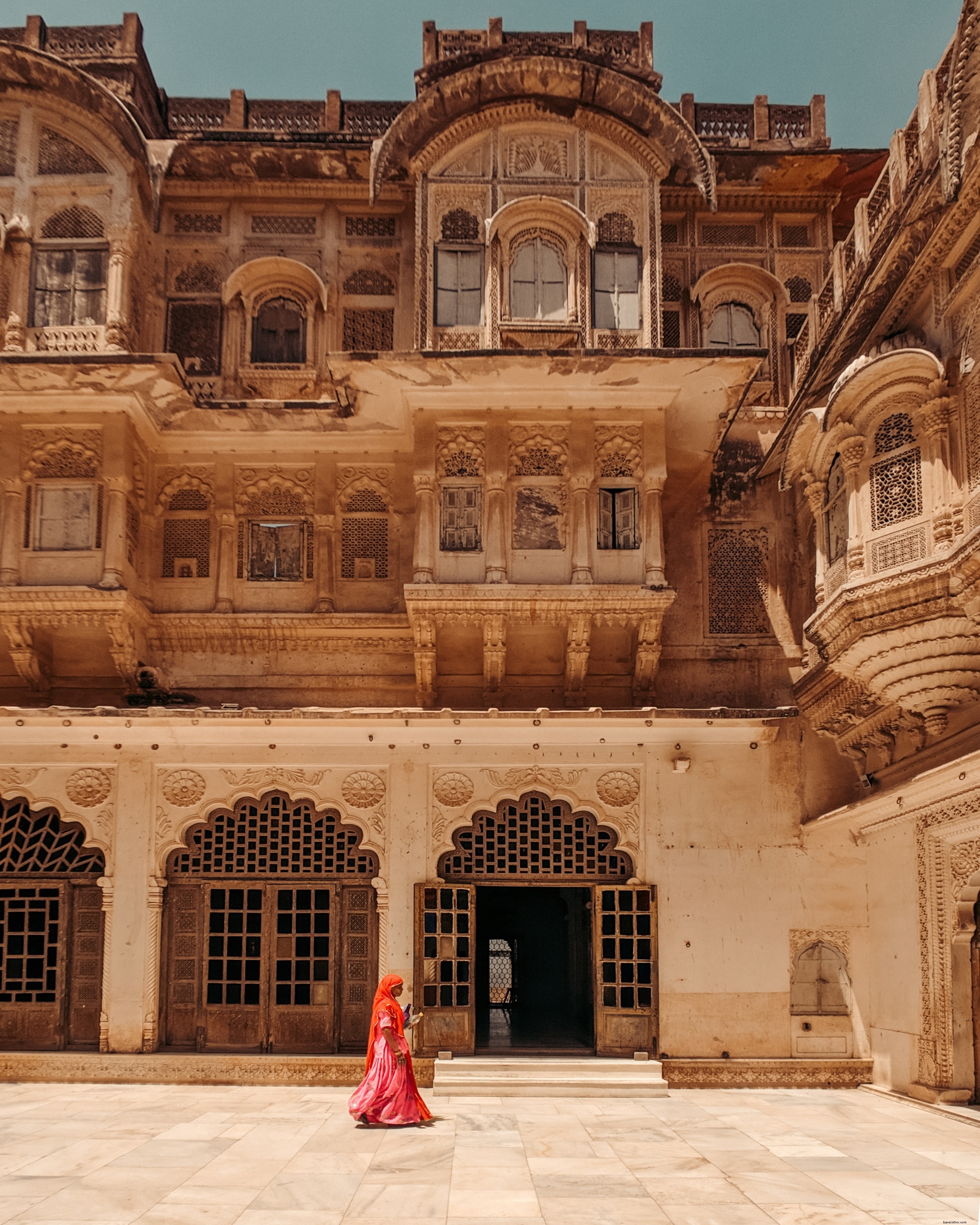 Stunning Photo: Person Strolling in Sunlit Open-Air Courtyard