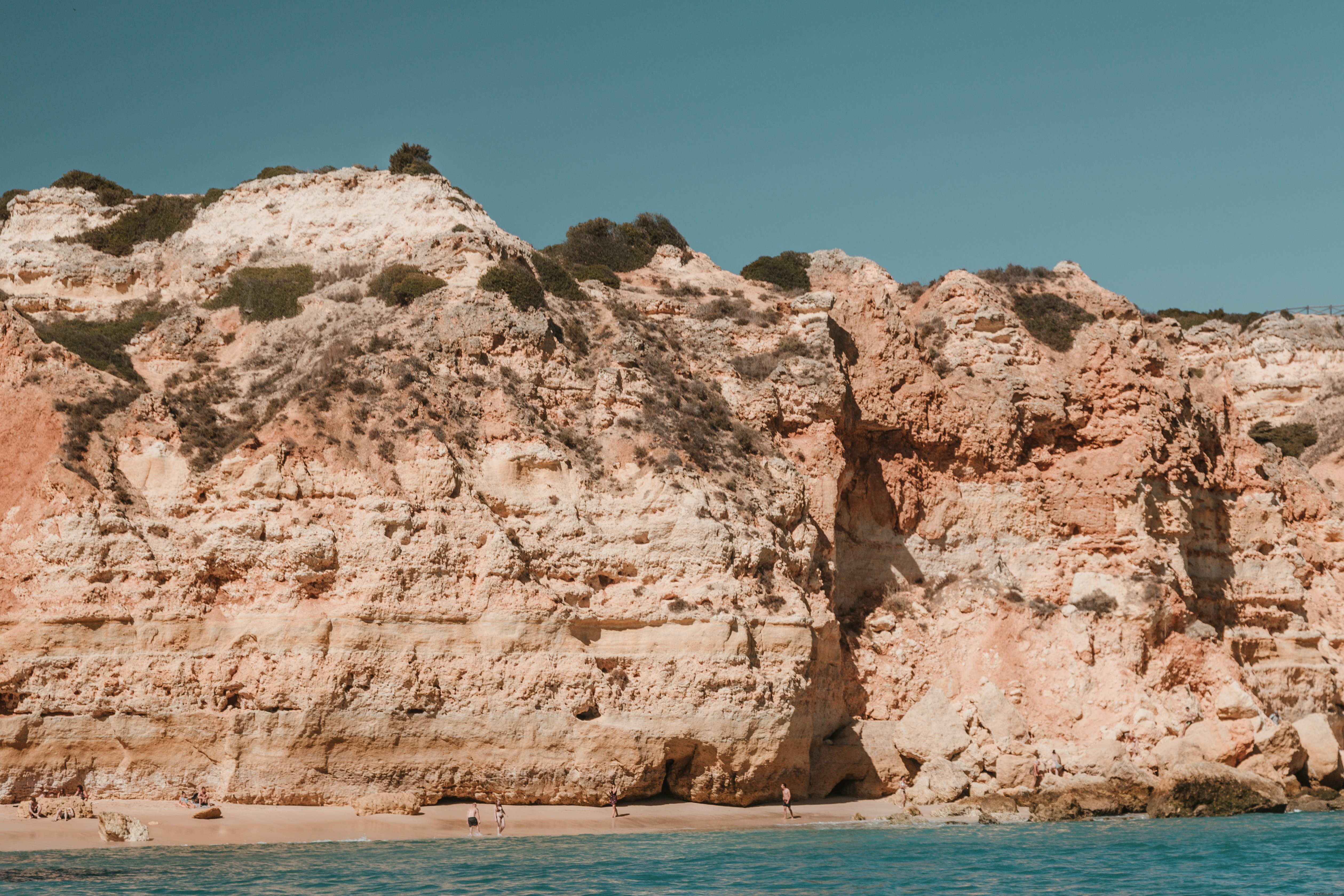 Stunning Sun-Baked Cliffs Towering Over Pristine Sandy Beach – Breathtaking Photo
