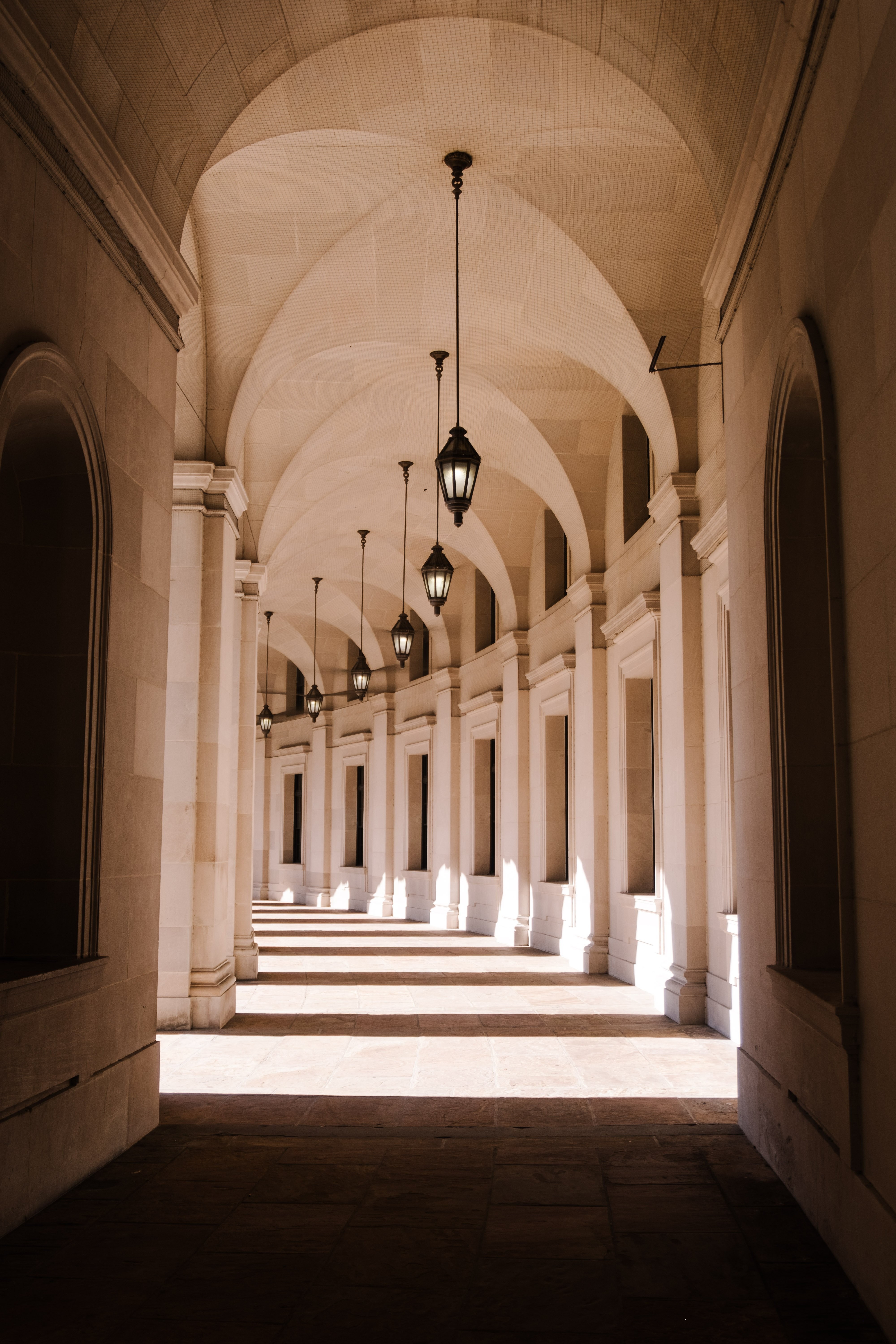 Elegant White Arched Hallway Bathed in Natural Light – Stunning High-Res Photo