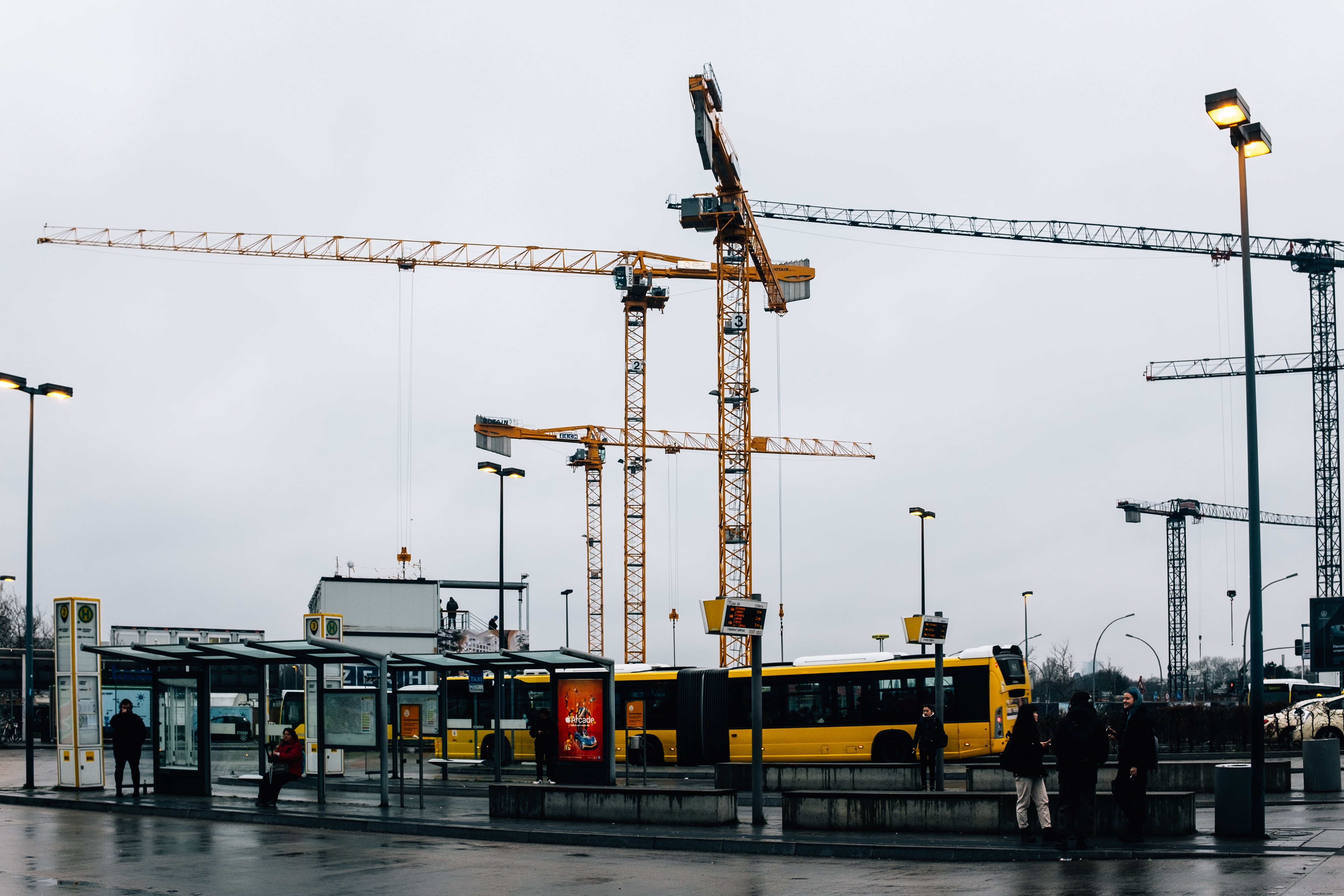 Striking Photo: Tower Cranes Looming Over City Buses