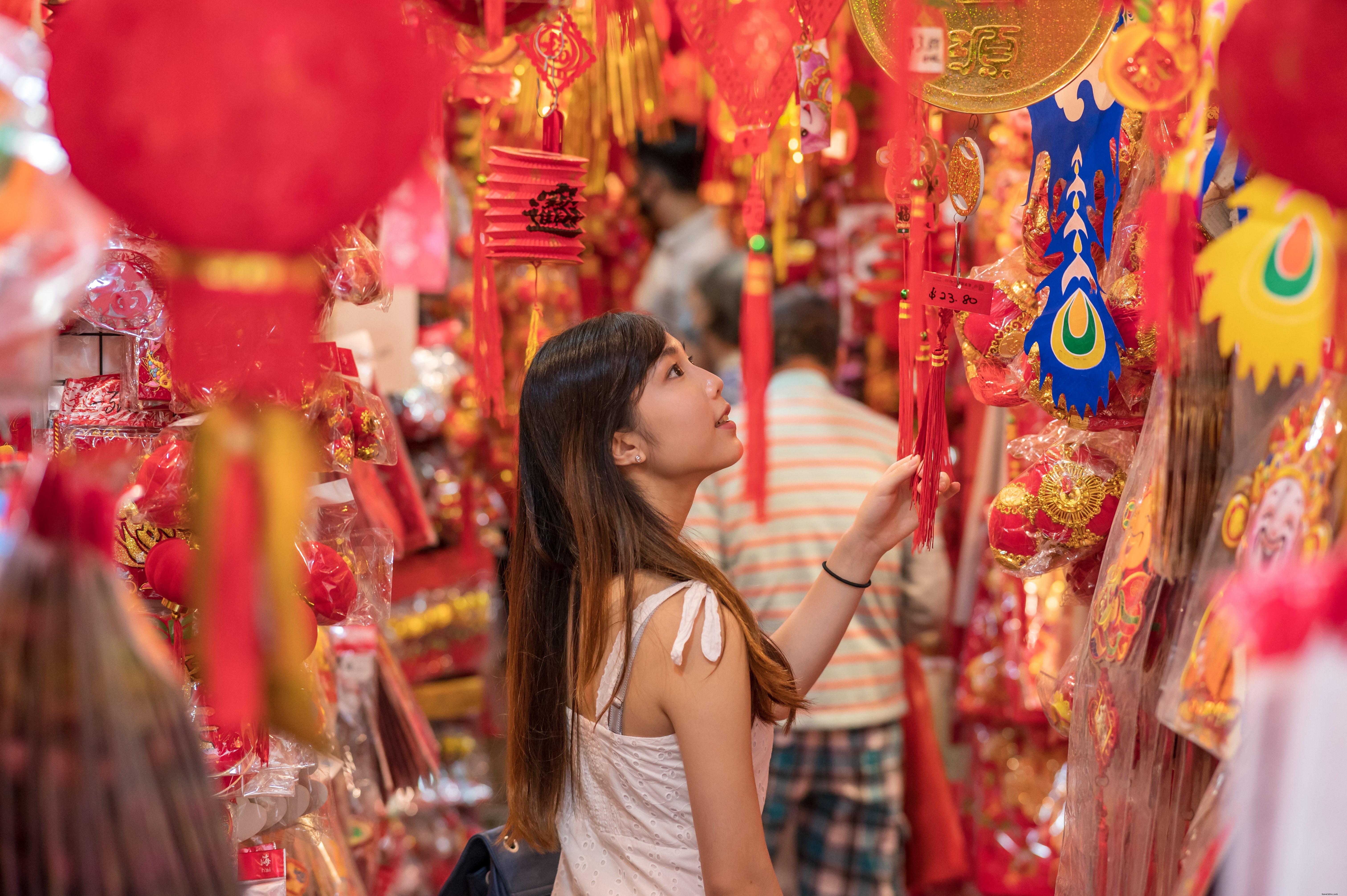 Captivating Market Photo: Person Surrounded by Vibrant Red and Gold Items