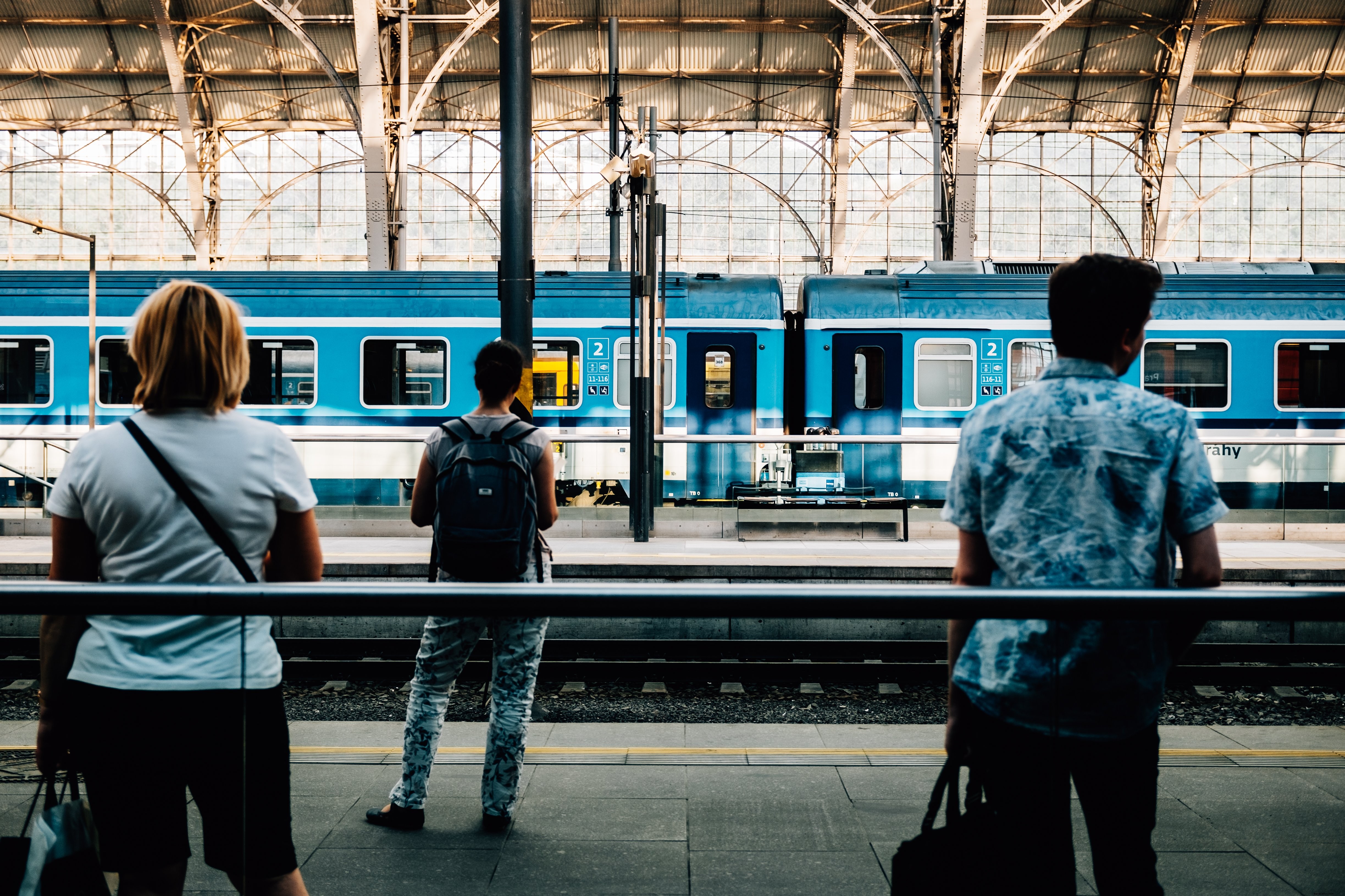 Captivating Photo: Travelers Eagerly Awaiting Train Arrival at the Station