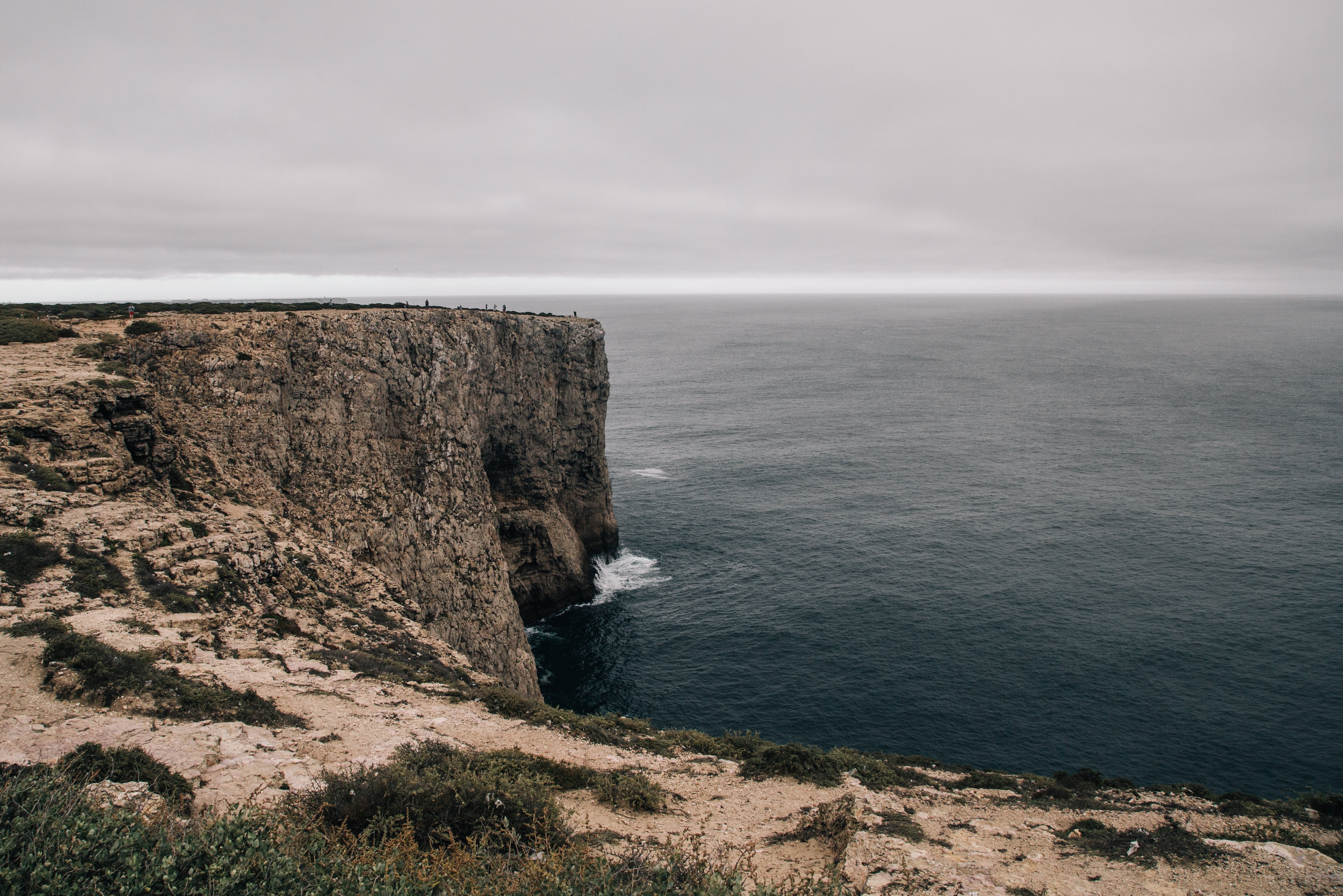 Stunning Landscape Photo: Rocky Plateau Curving Around a Serene Little Bay