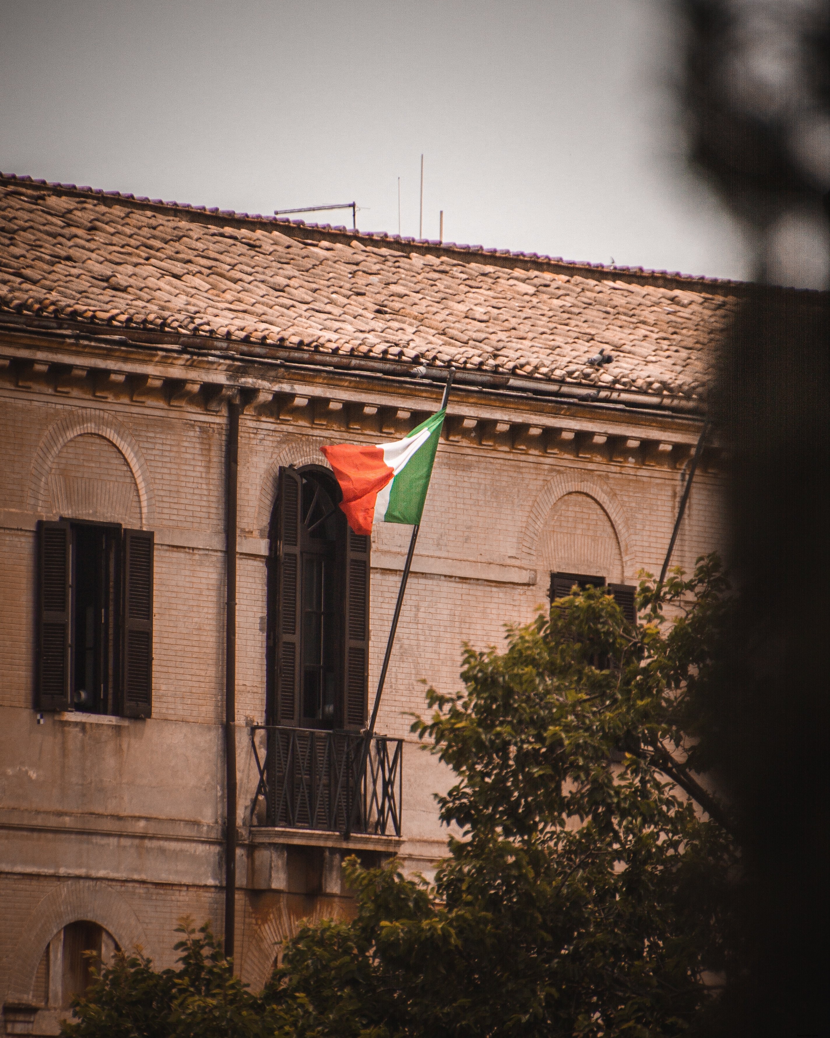 Vibrant Italian Flag Waving Proudly from Balcony – Stunning Photo