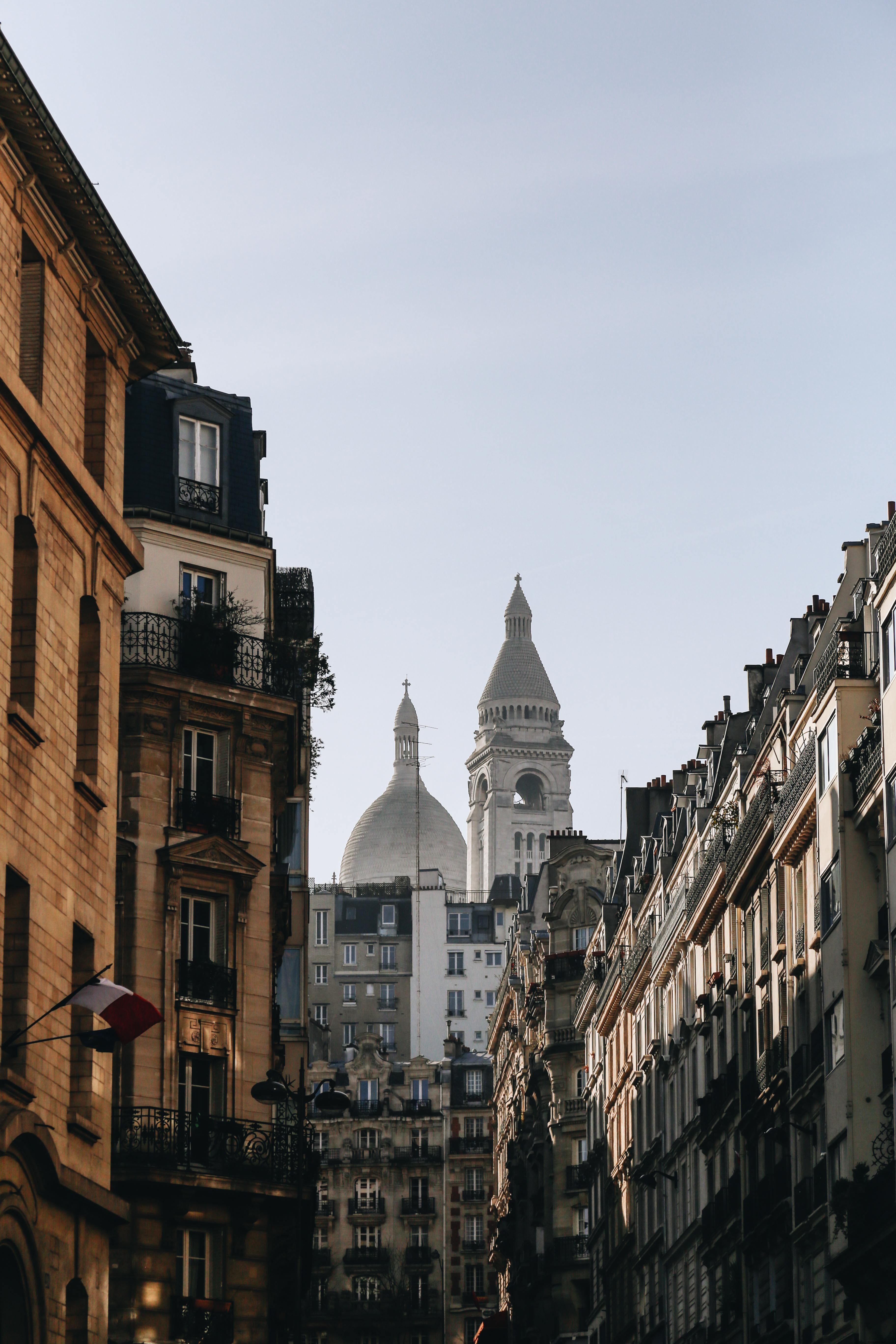 Stunning Urban Photo: Towering Building Peaks Over Apartment Balconies